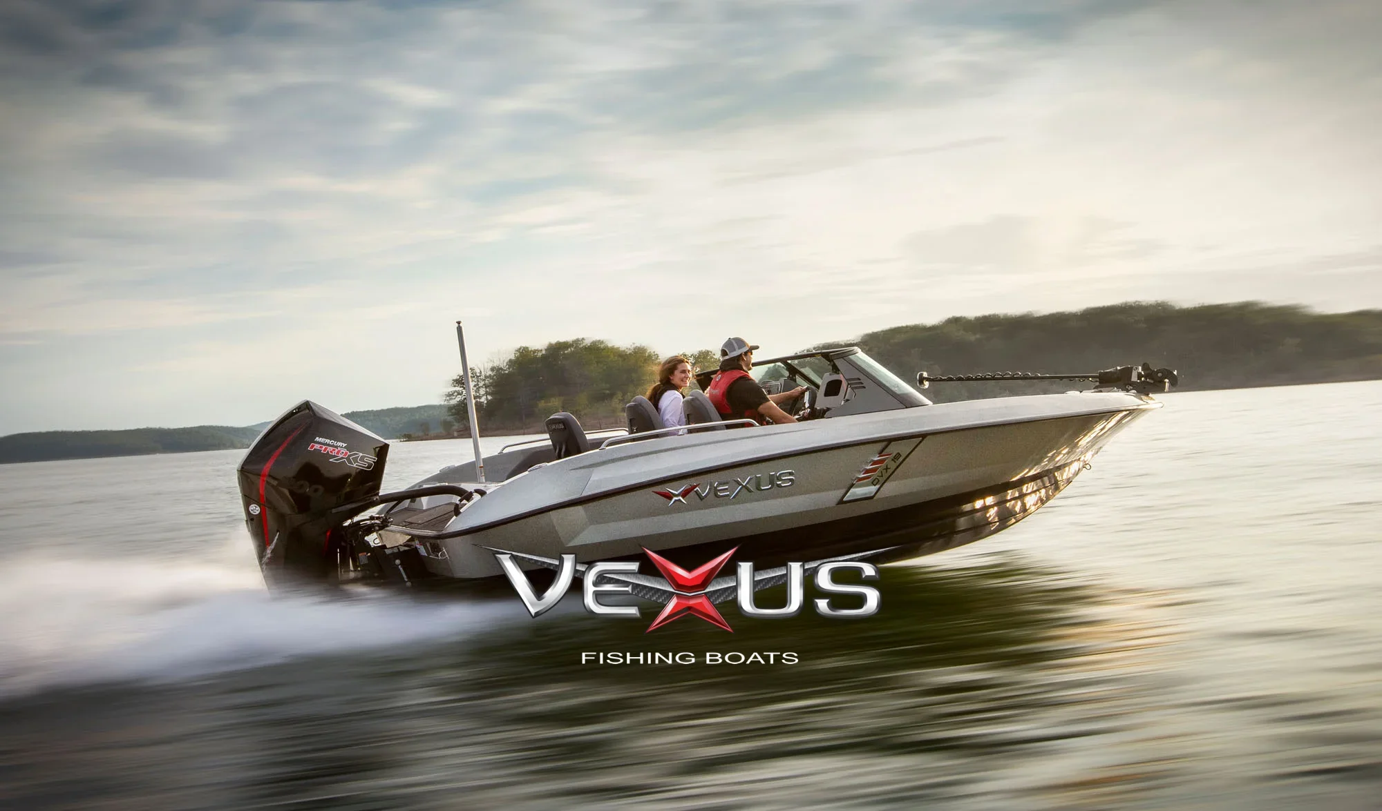 Vexus fishing boat speeding across a lake with two people on board.
