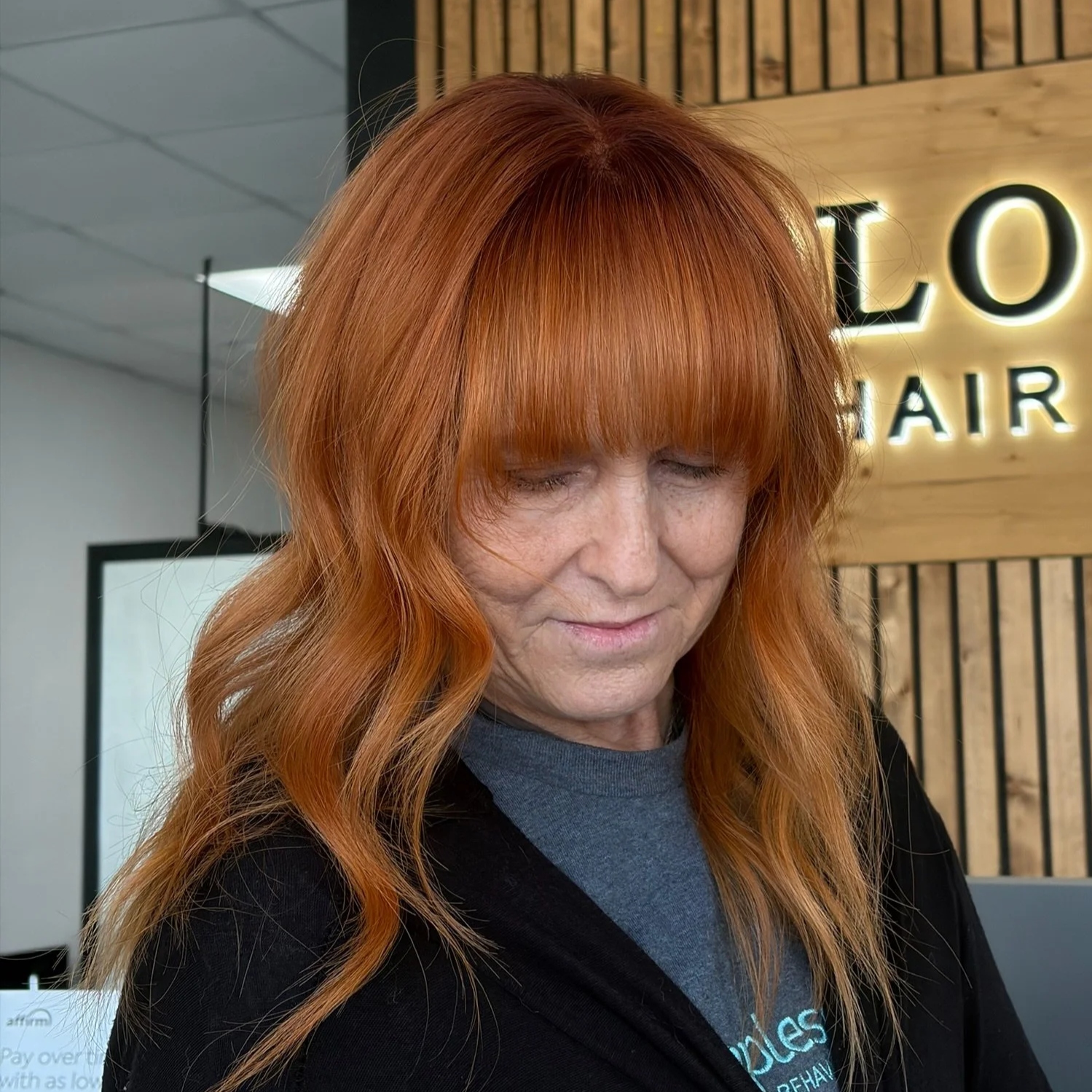 Natural-looking mesh integrated hair topper for added coverage and fullness at BLOOM HAIR CO.
