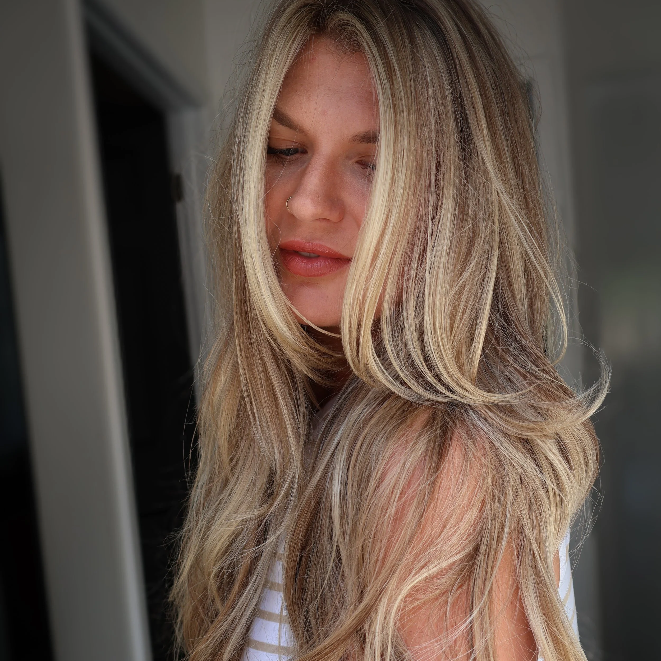 Dimensional blonde hair color with soft blended highlights and 22 inch extensions at BLOOM HAIR CO.