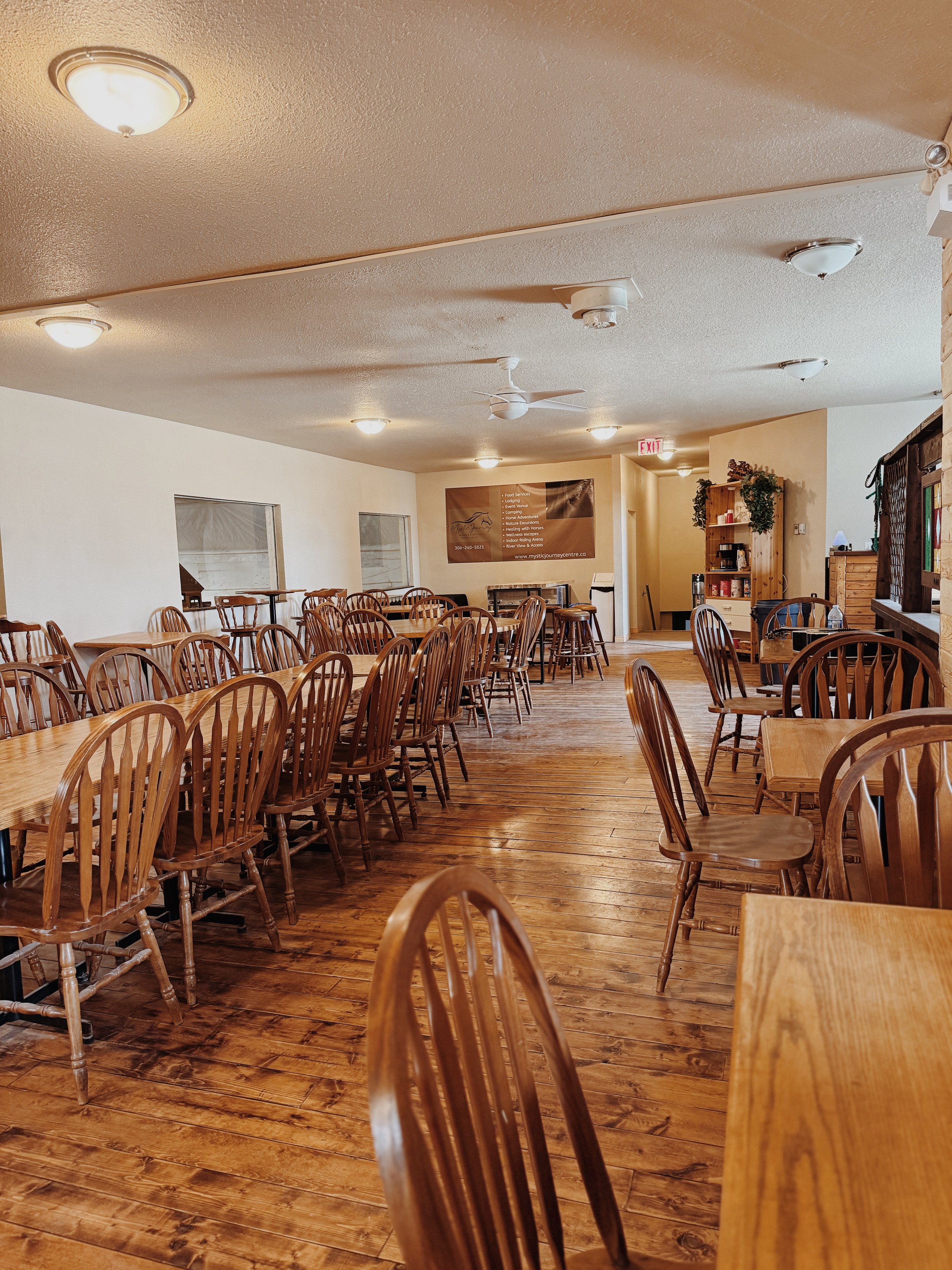 room with wooden flooring and wooden tables and chairs