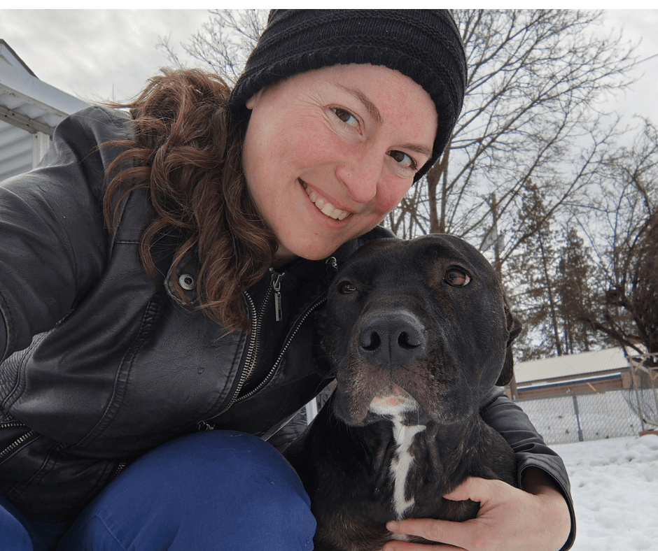 girl wearing beanie with black and white pitbull mix