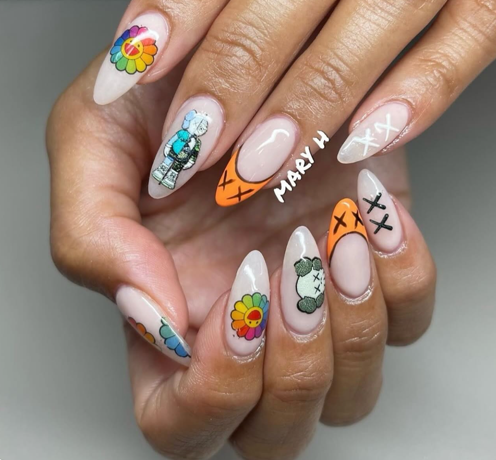 Nail art featuring cartoon characters, colorful flowers, and text, with a mix of bright colors and playful designs.