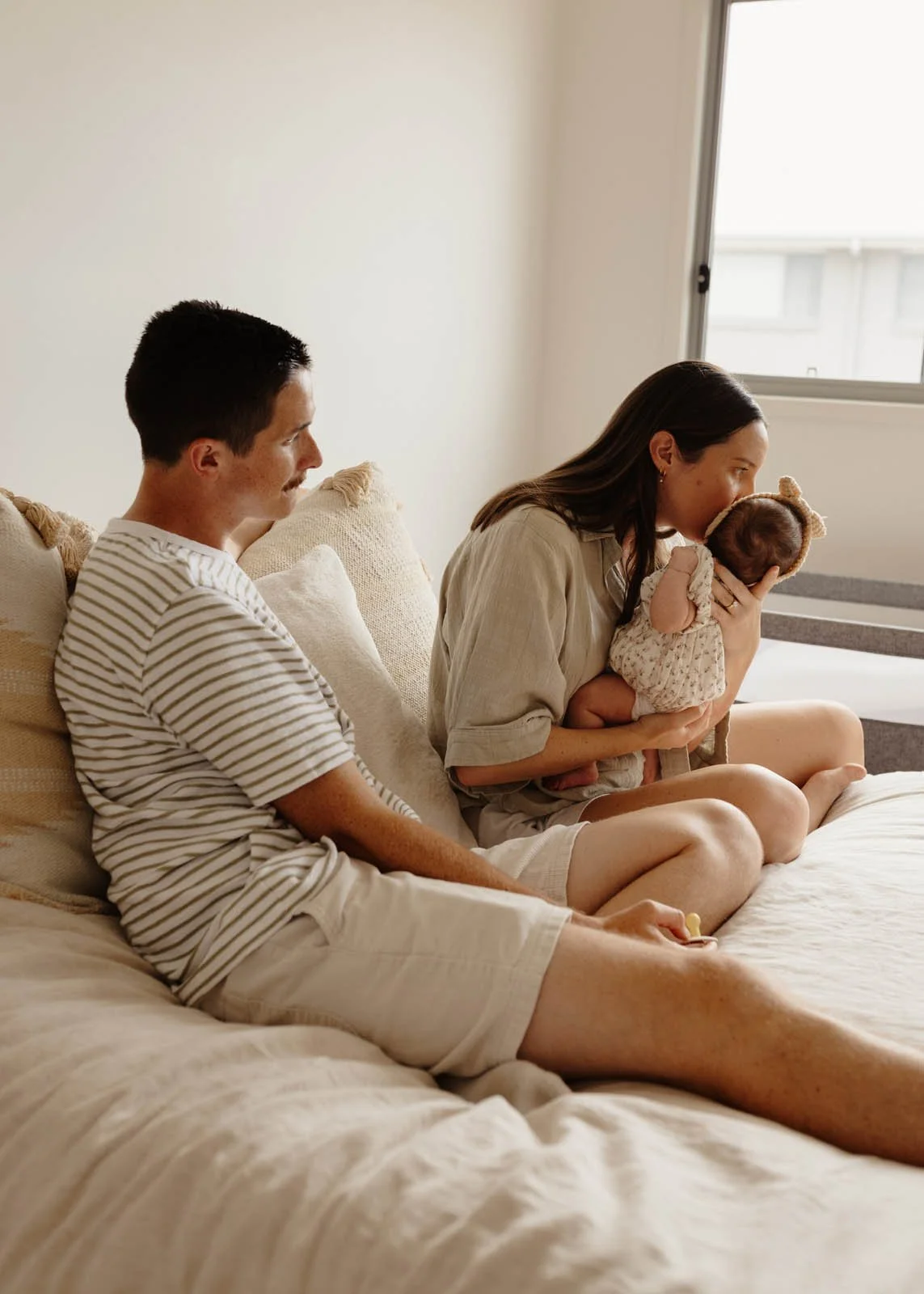 brisbane-newborn-photographer-mother-kissing-baby-on-bed.jpg