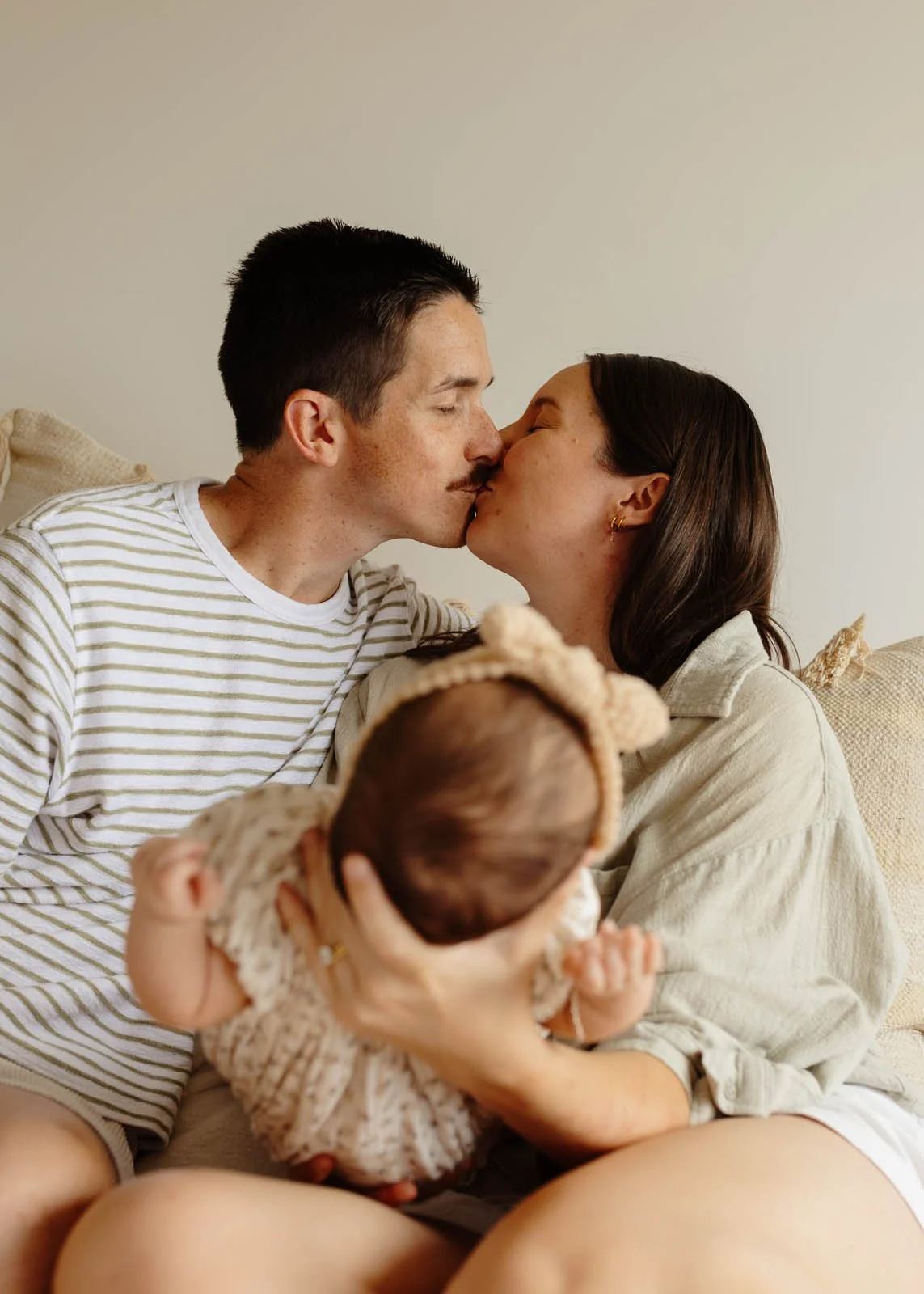 brisbane-newborn-photographer-parents-kissing-with-baby.jpg