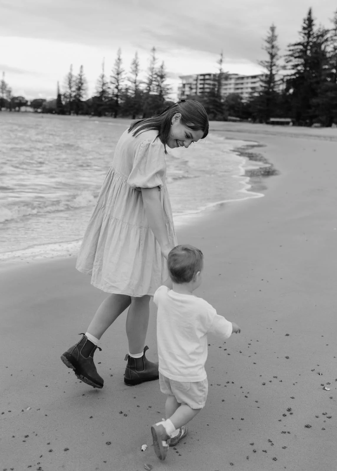 gold-coast-family-photographer-mother-walking-with-child-shoreline.jpg