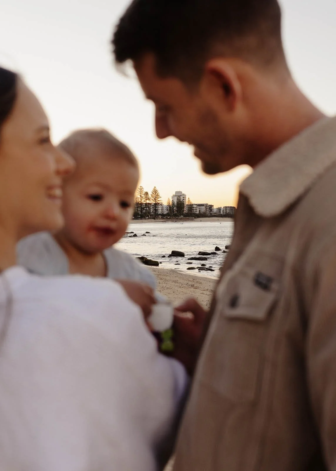 gold-coast-family-photographer-baby-held-by-parents-close-up.jpg