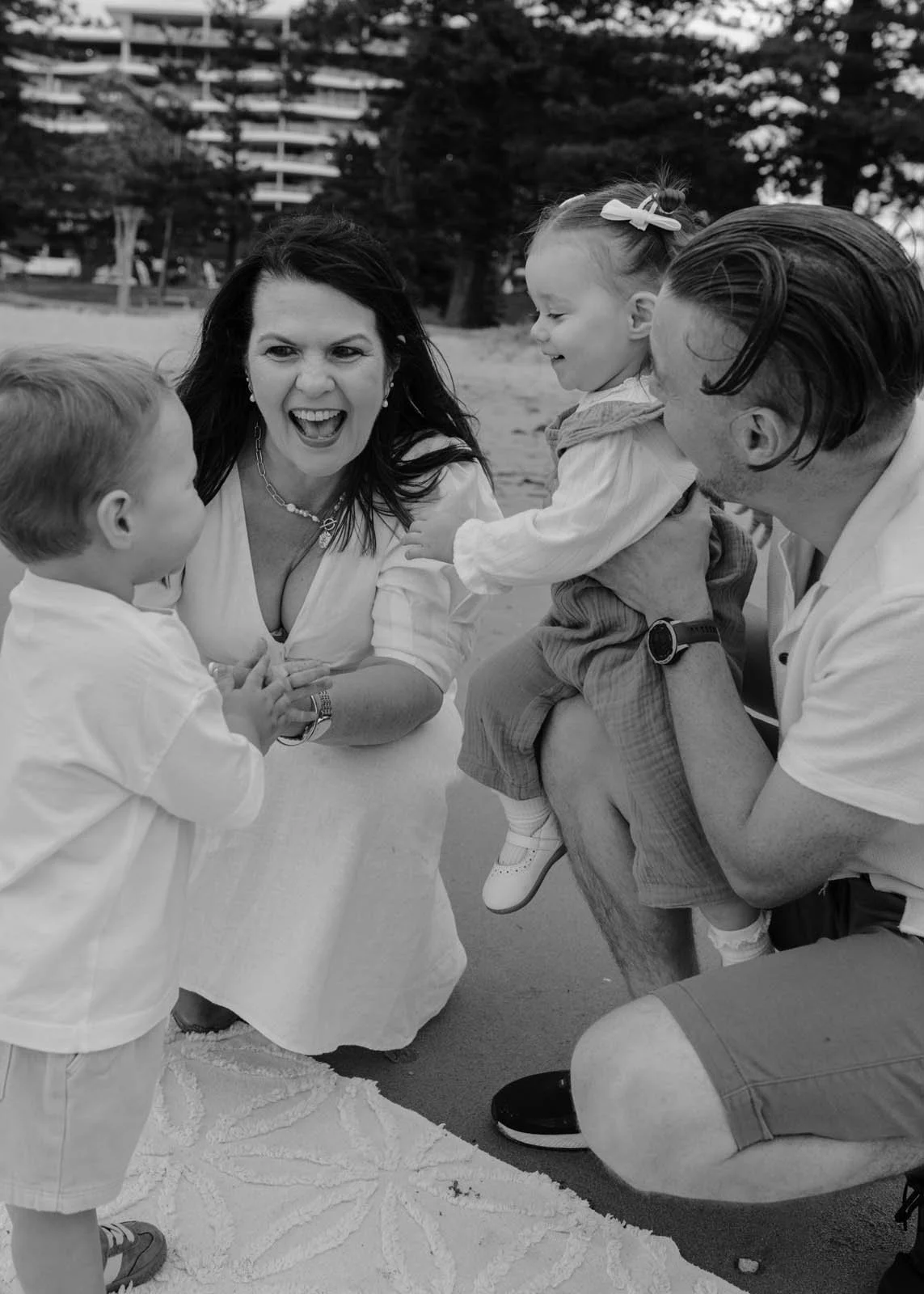 gold-coast-family-photographer-family-laughing-together-beach.jpg