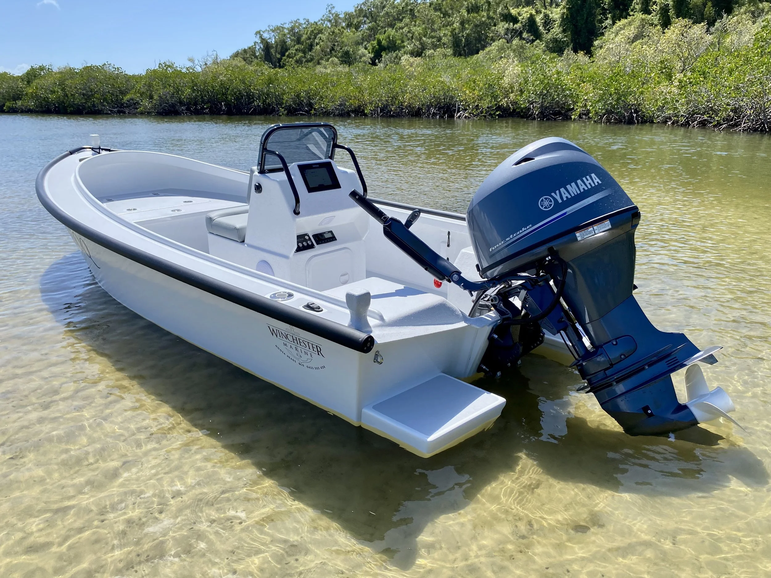 Handcrafted dory boat cruising Noosa waterways