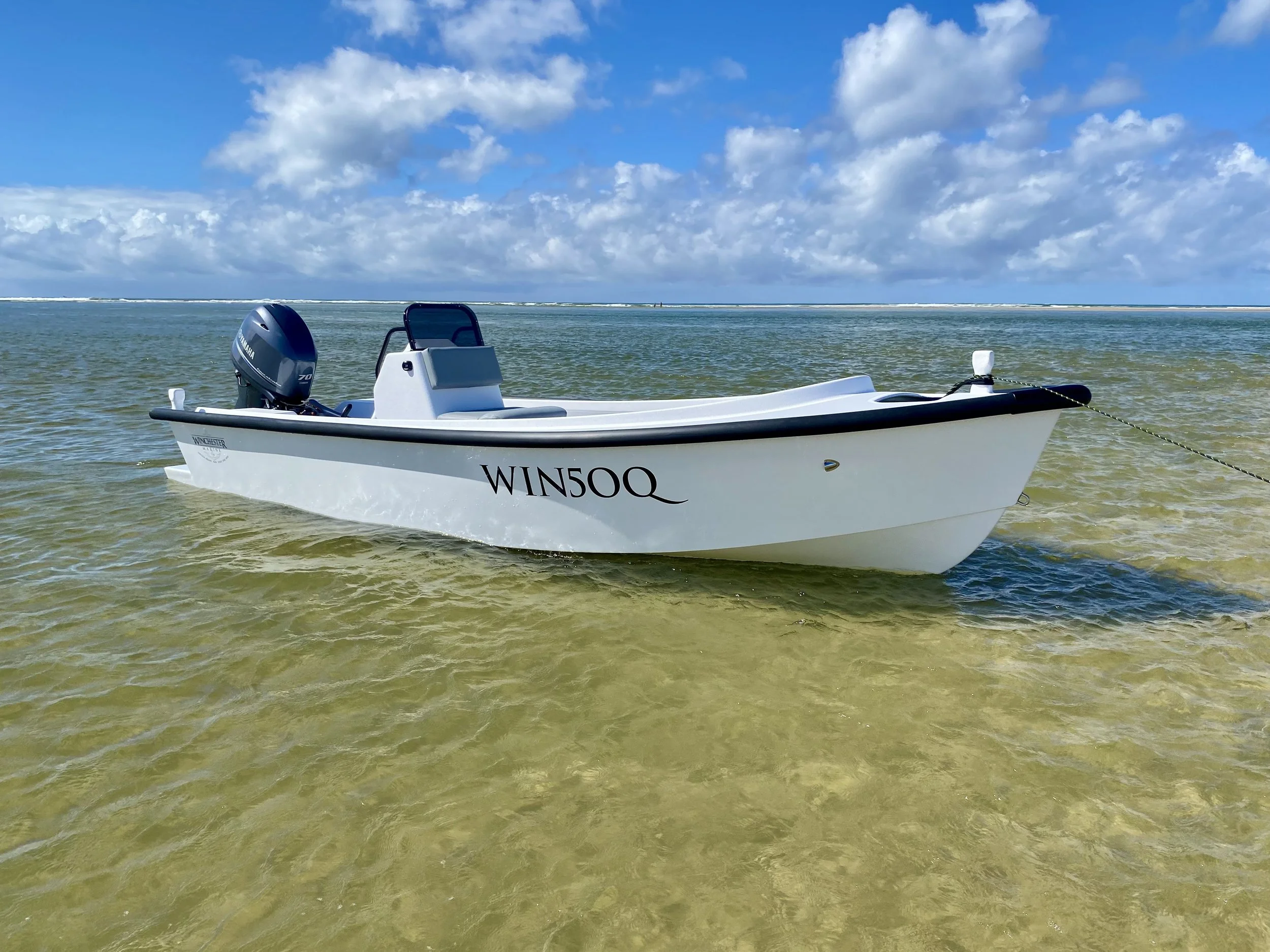 Handcrafted dory boat cruising Noosa waterways