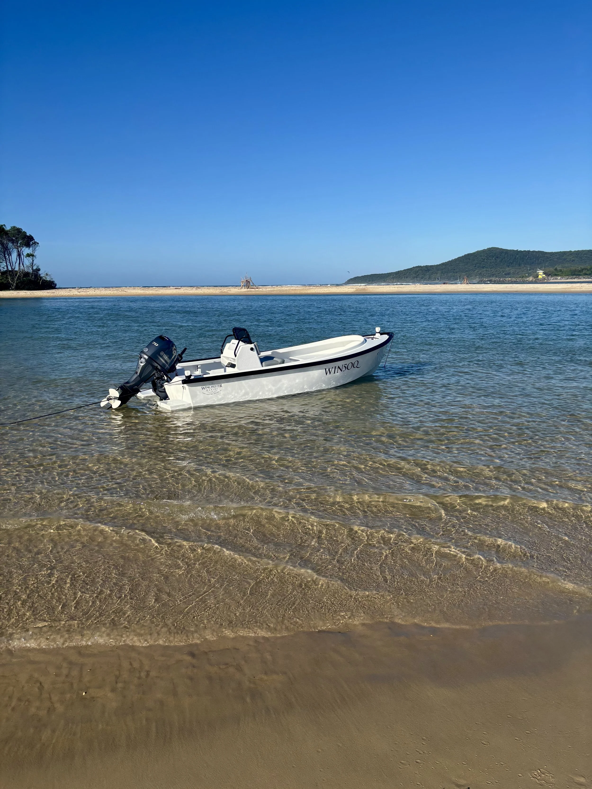 Handcrafted dory boat cruising Noosa waterways