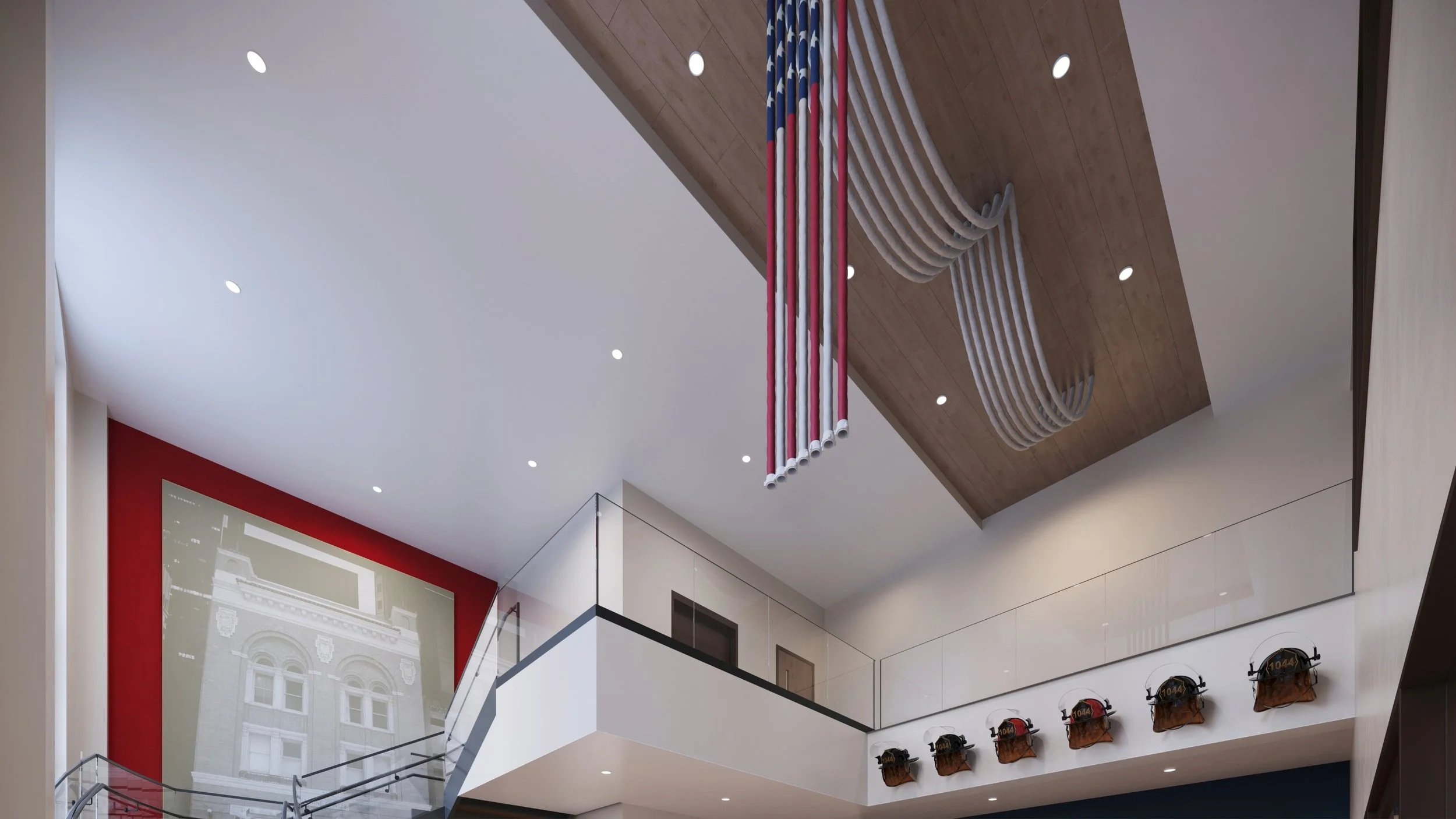 Interior of a modern building with a wooden ceiling, hanging colorful pipes, and a wall with firefighting helmets displayed on hooks.