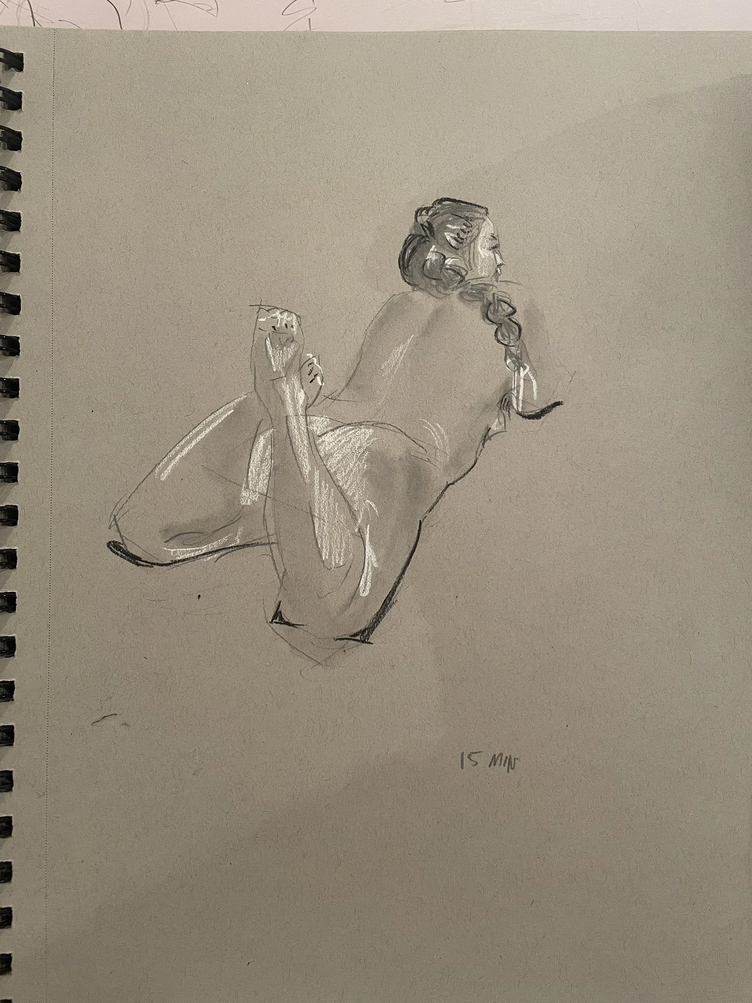 Sketch of a woman in a pose with her back facing right, her hair in a bun, and her hands near her face.