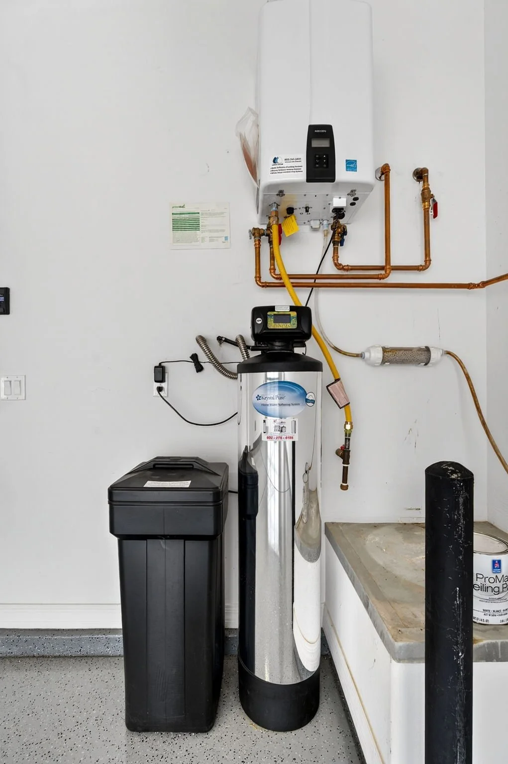 Water softening system with filtration unit, a high-capacity water softener, and a reverse osmosis filter in a utility room.