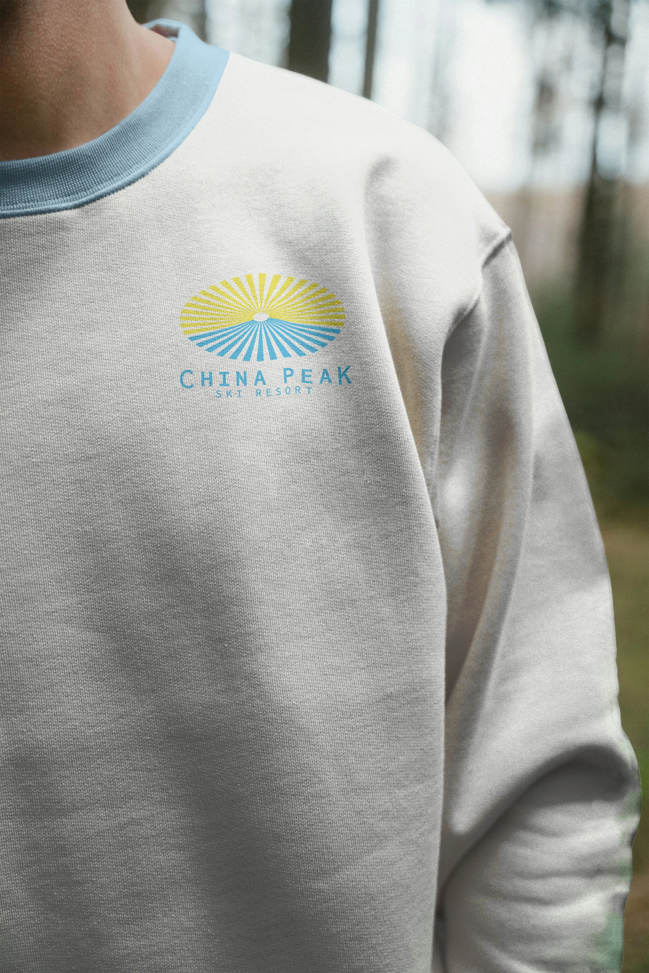 Close-up photo of t-shirt front with full color China Peak Ski Resort logo on left chest