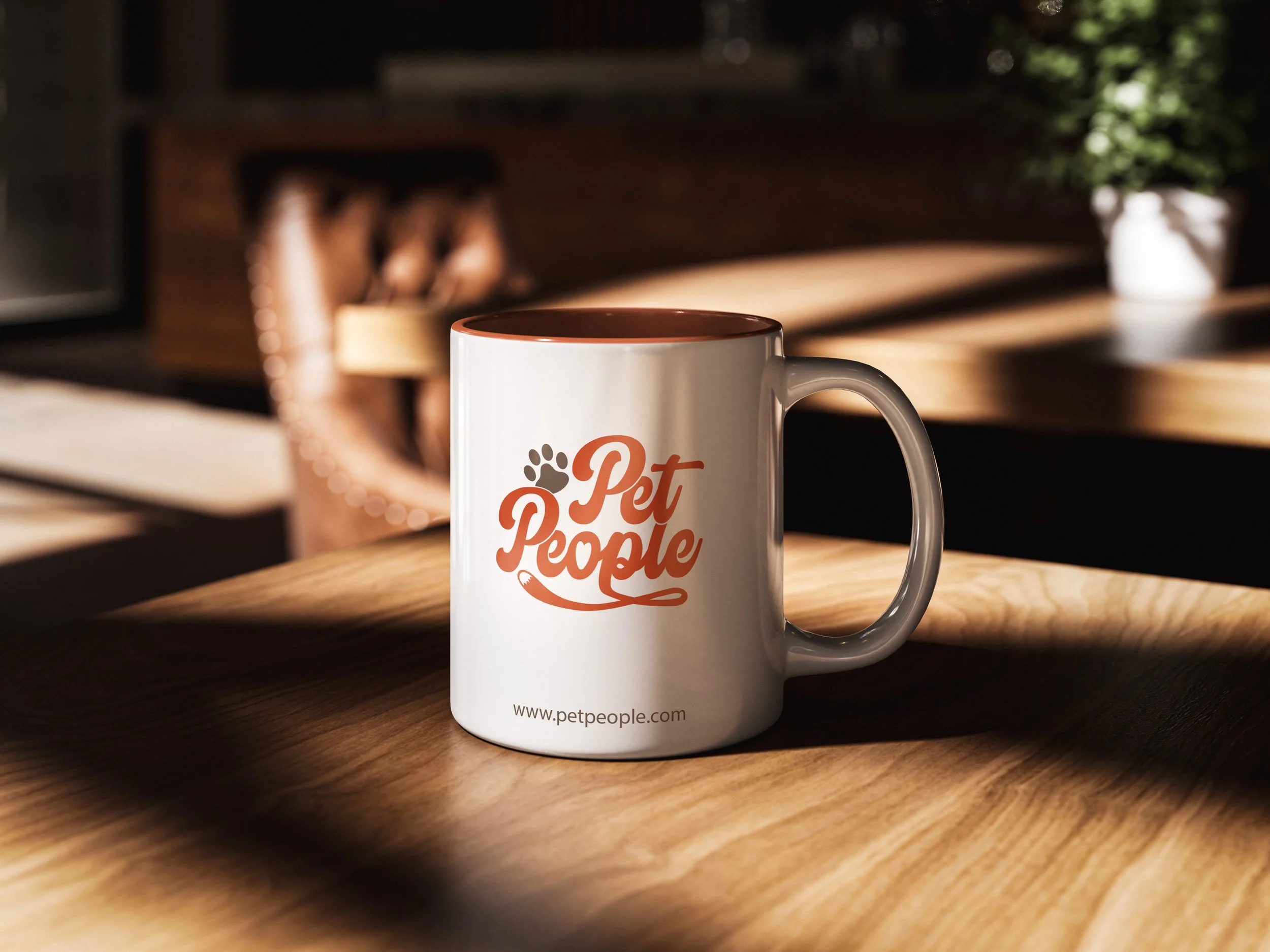Photo of ceramic coffee mug with full color Pet People logo and website address