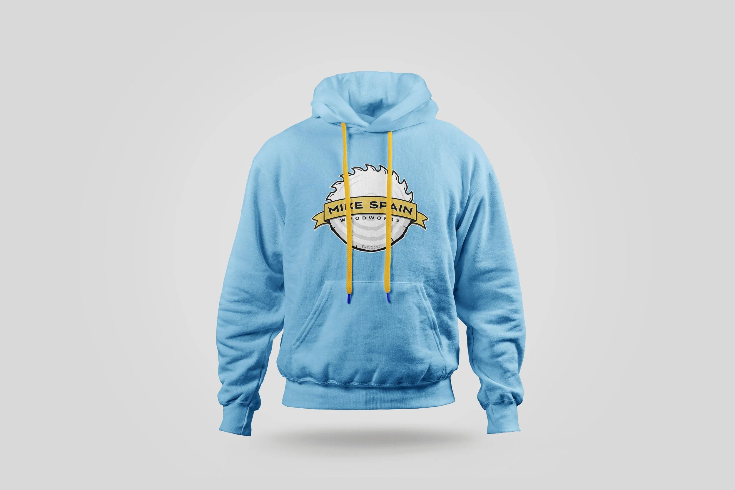 Photo of light blue hoodie sweatshirt with full color Mike Spain Woodworks logo centered on front