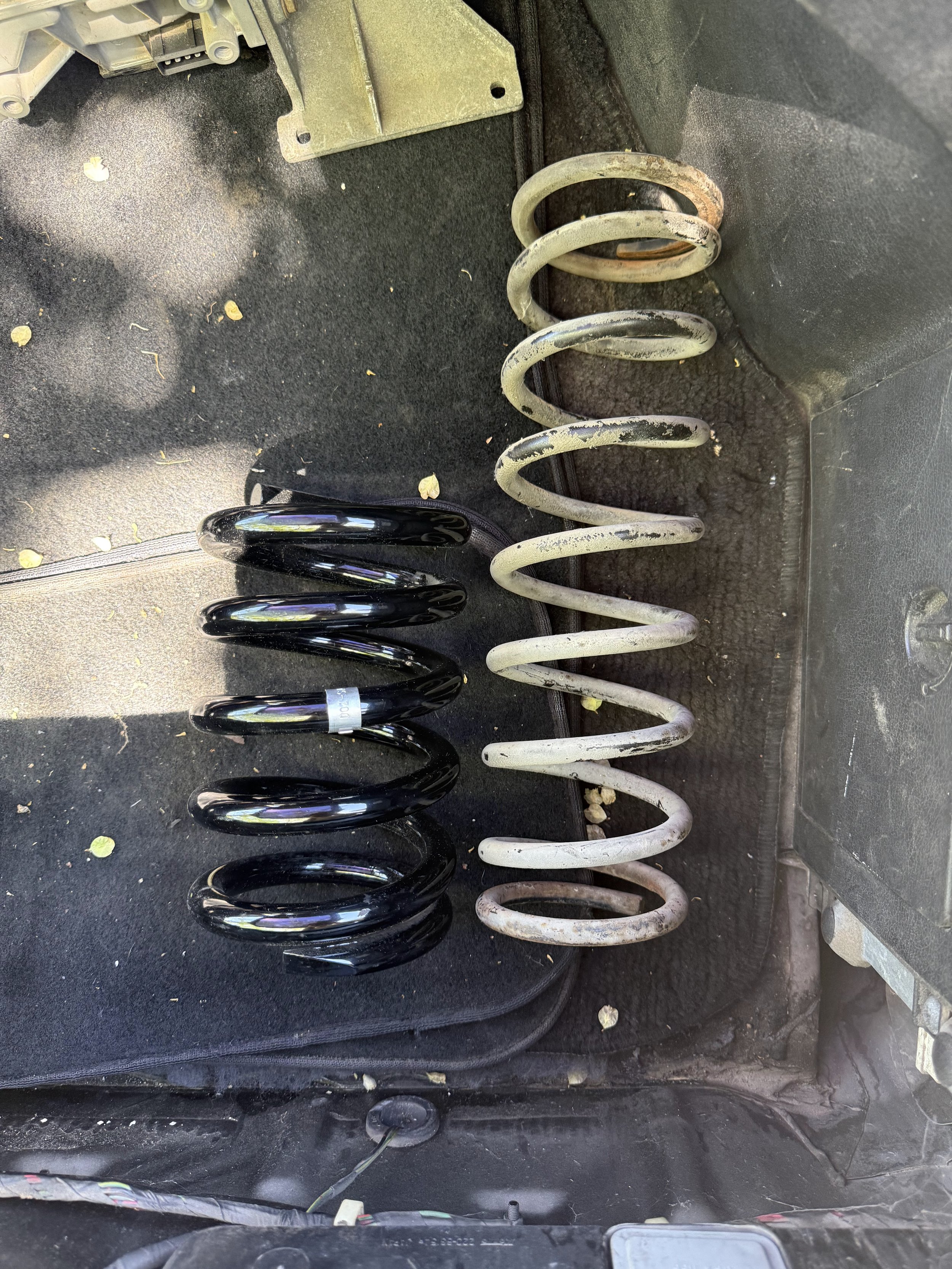 Comparison of an original 41 year old 1984 Nissan 200SX S12 rear suspension spring next to a new lowering springs to replace it.