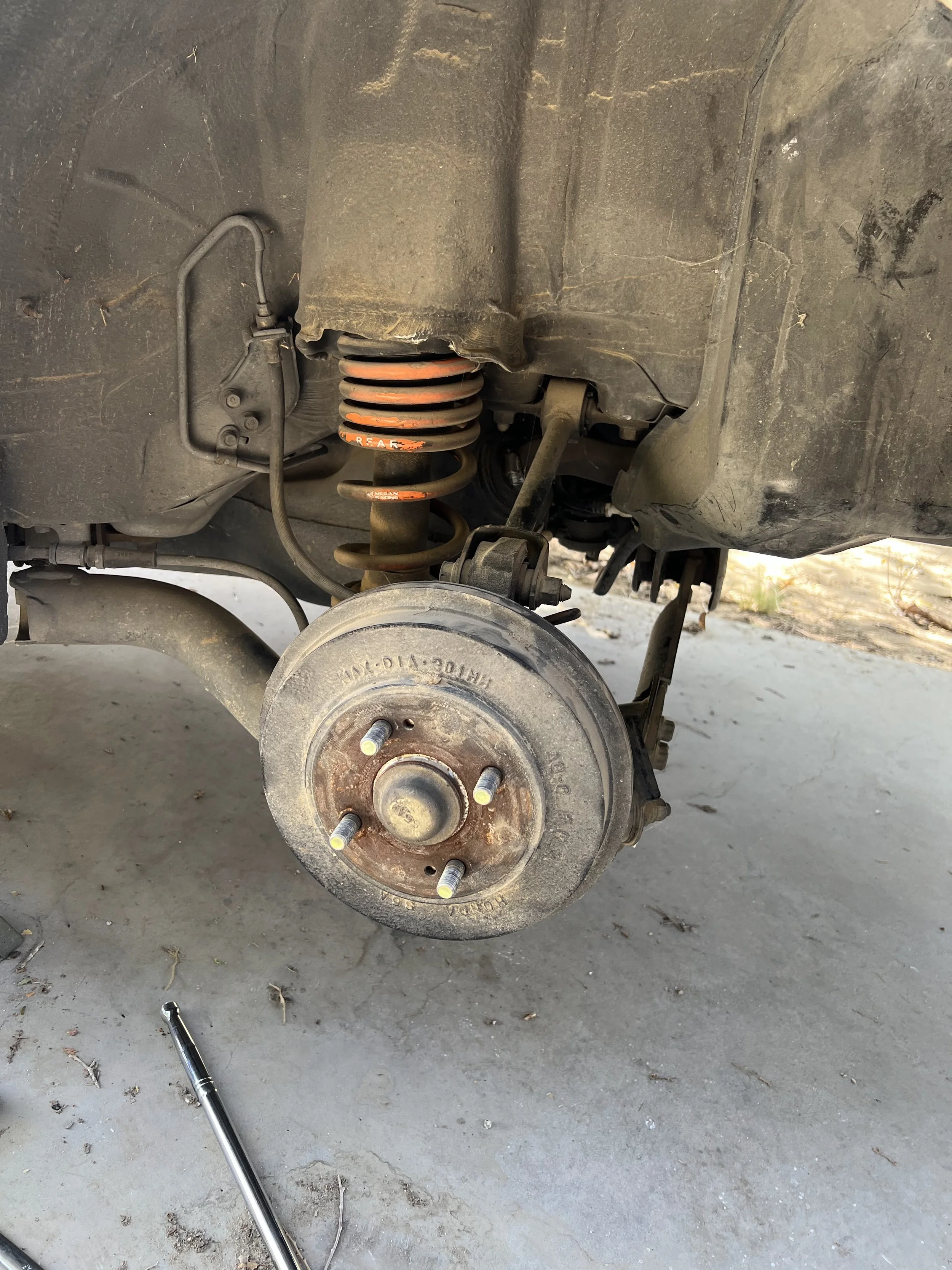 Overview of a 2001 Honda Civic's rear suspension before replacing the lowering springs.