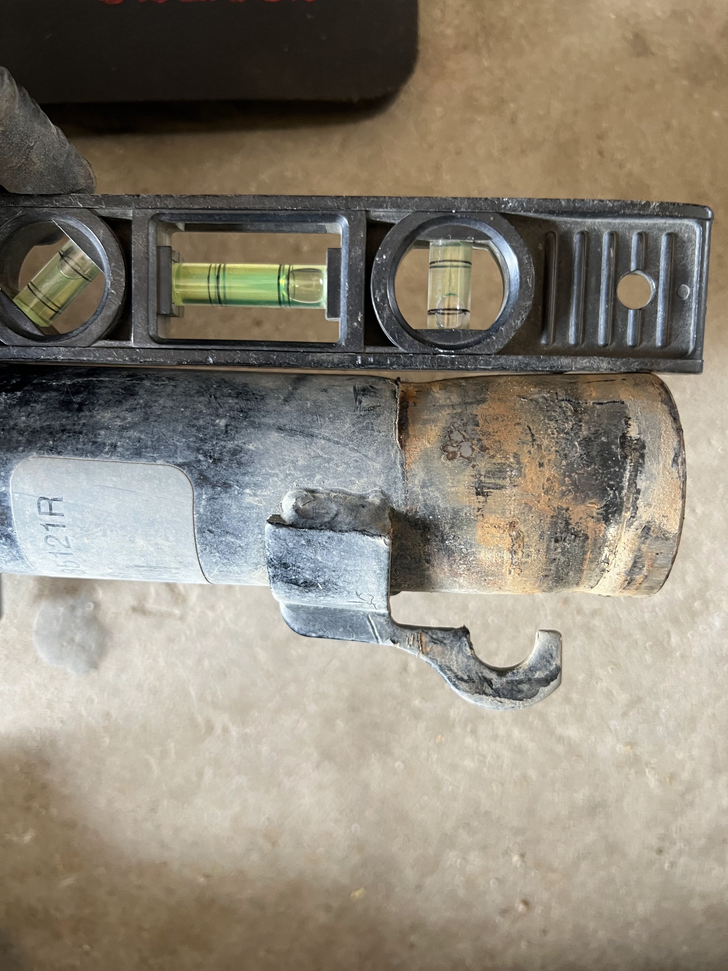 Close-up of a bent shock absorber base from a 2010 Ford Focus SE.