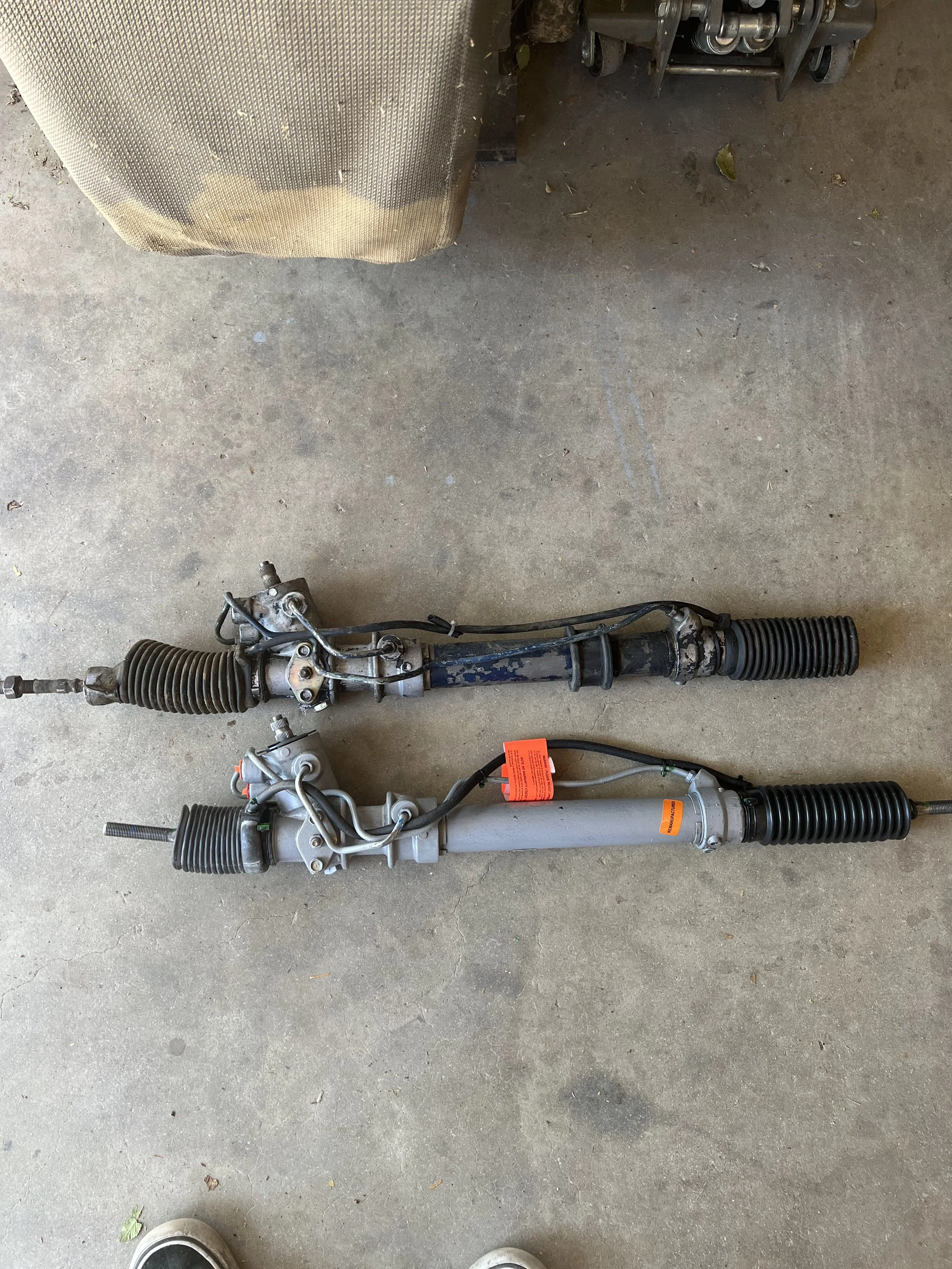Comparison of a 1984 Nissan 200SX S12 steering rack next to its replacement from a Nissan S13.