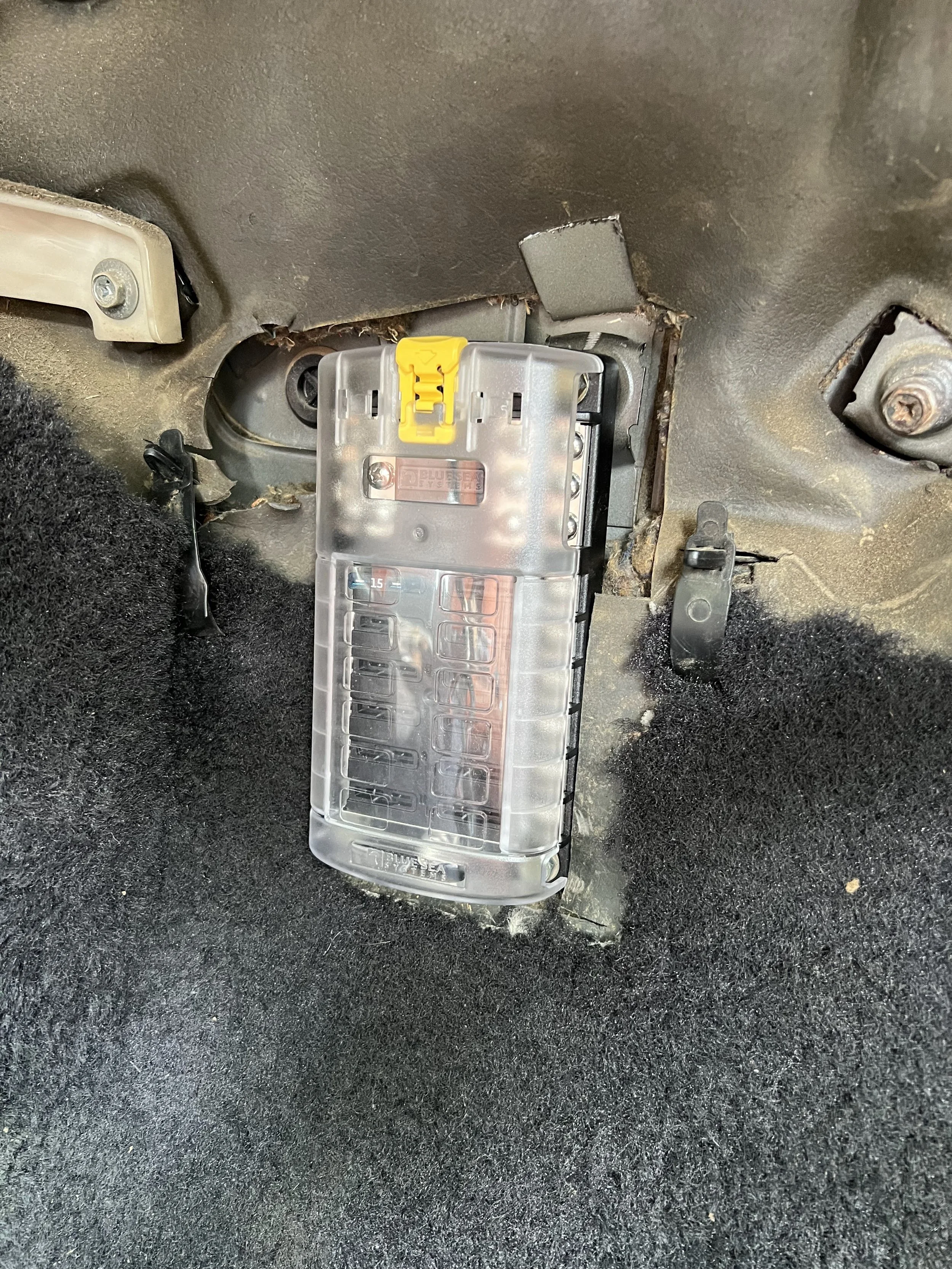 Aftermarket fuse box mounted on a 1984 Nissan 200SX S12 firewall beneath the dash.