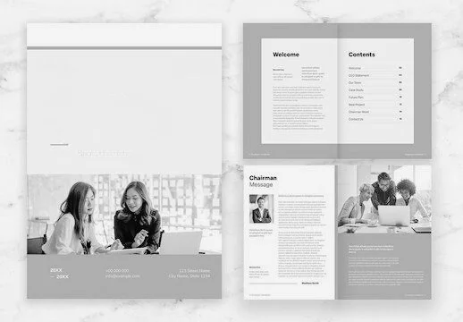 Open brochure or magazine pages displaying a welcome message, table of contents, chairman's message, and a photo of two women working together.