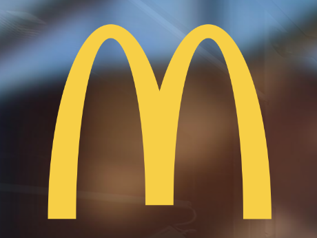 Yellow McDonald's golden arches logo on a dark background.