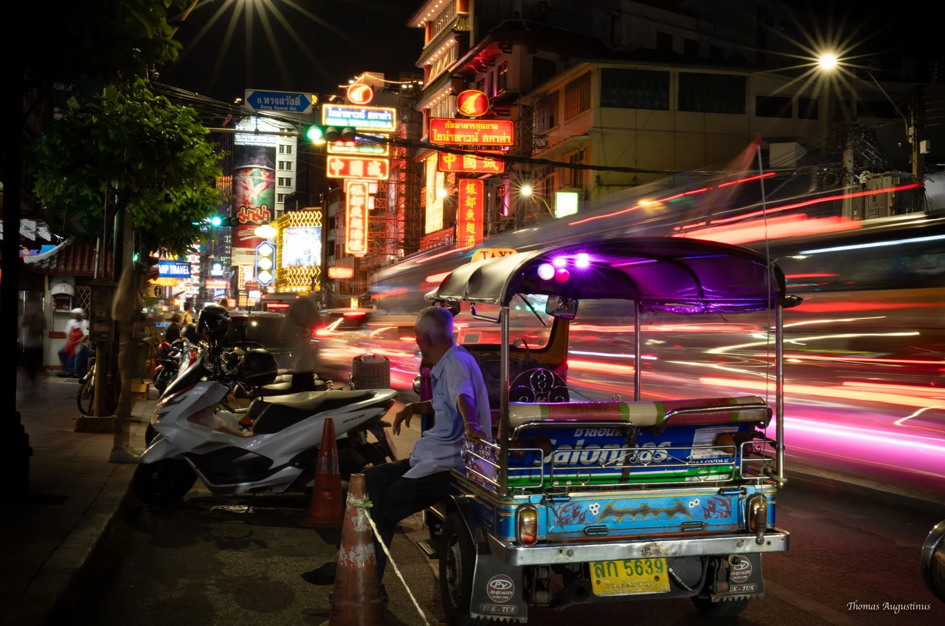 Tuk-tuk driver taking a pause in Bangkok