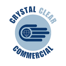 Logo with a blue circular design featuring a diamond and three horizontal lines, with the words "CRYSTAL CLEAR" at the top and "COMMERCIAL" at the bottom.