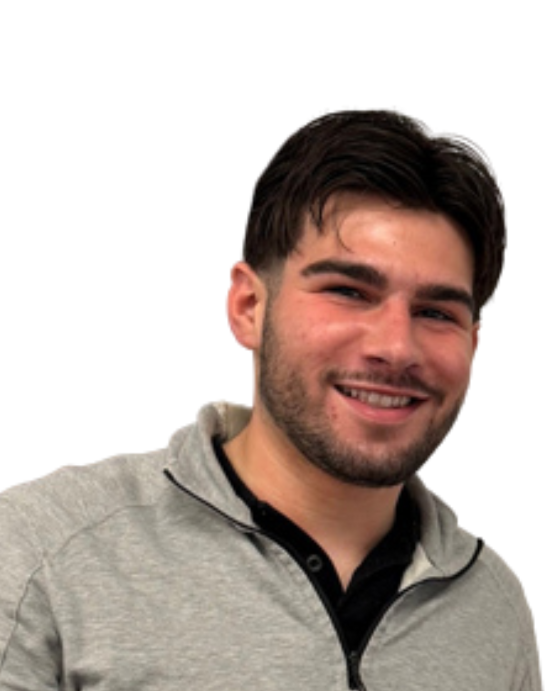 A smiling young man with dark hair and a beard, wearing a light gray zip-up jacket over a black shirt, against a plain white background.