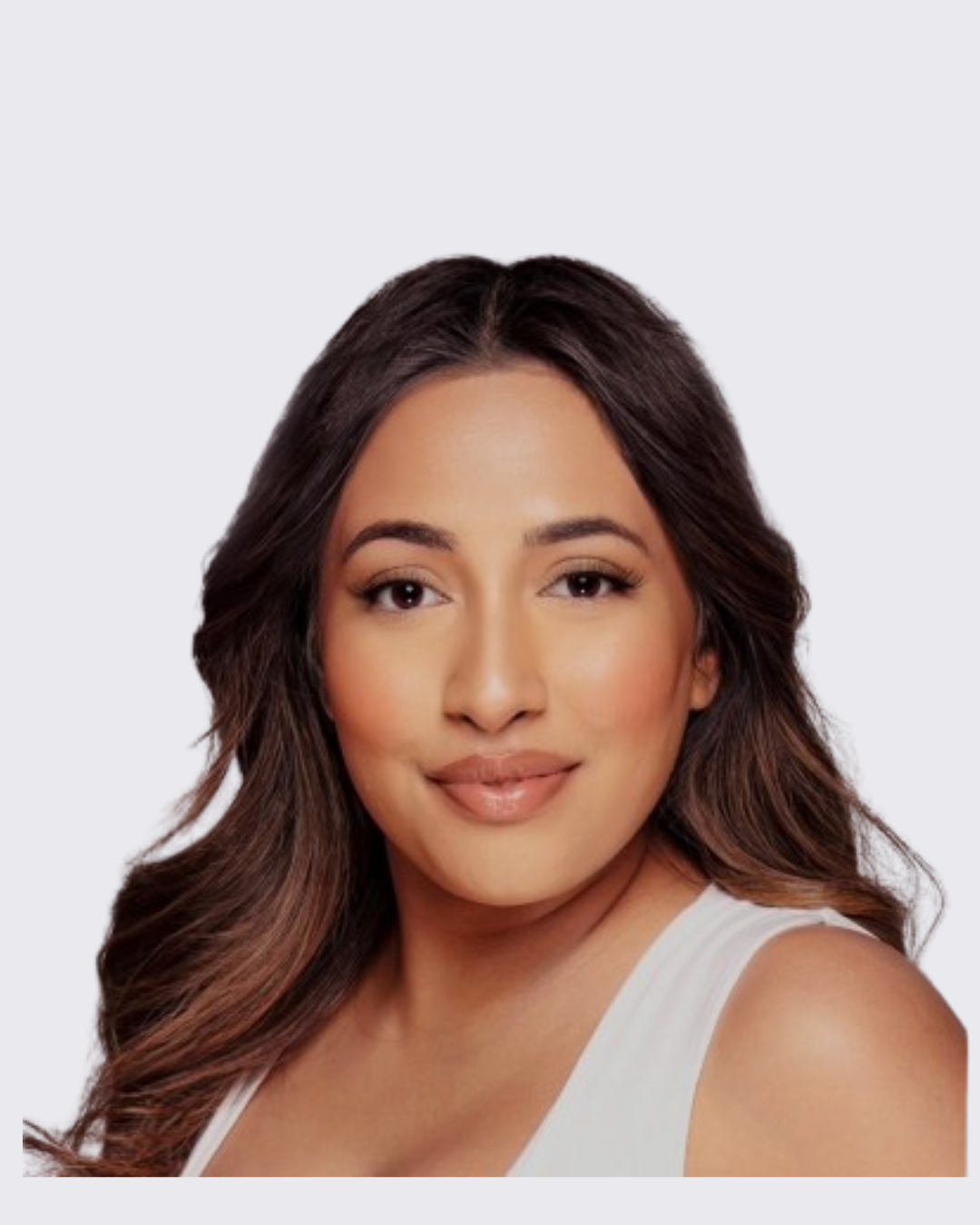 Portrait of a woman with long wavy hair, wearing a white sleeveless top, smiling softly, against a light background.