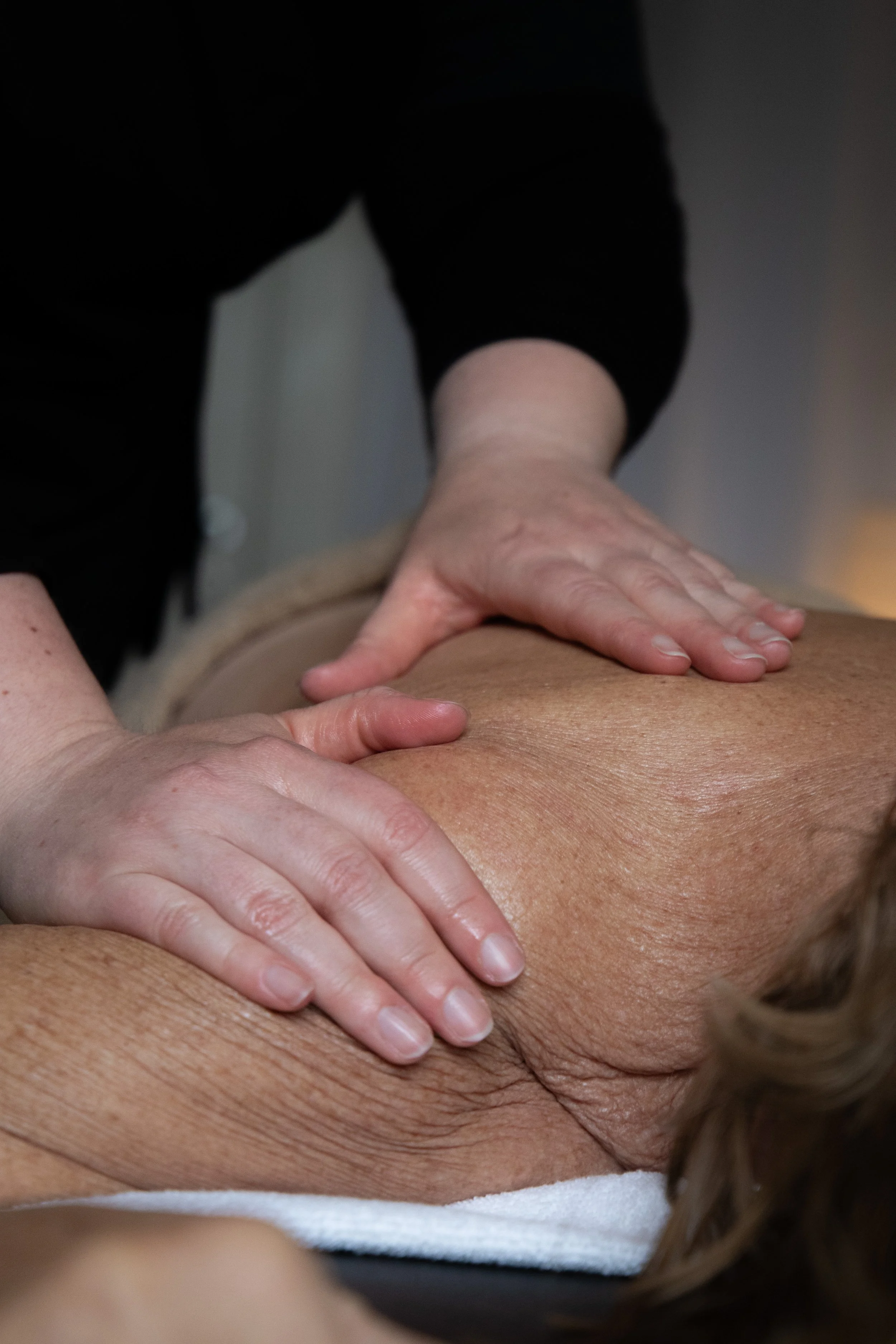 A person giving a massage to someone's back.