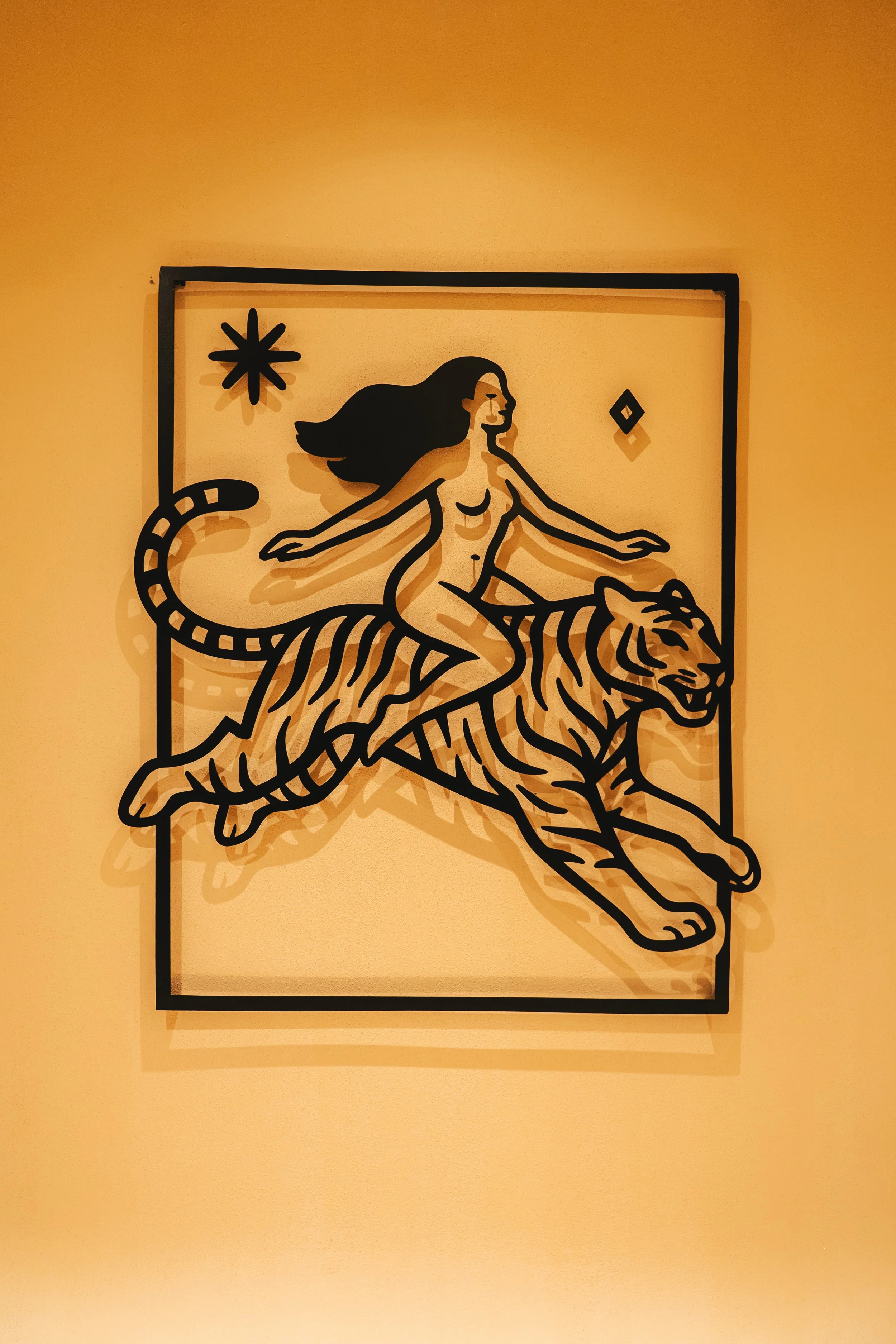 Tiger artwork on the studio wall, a nod to "ride the tiger"