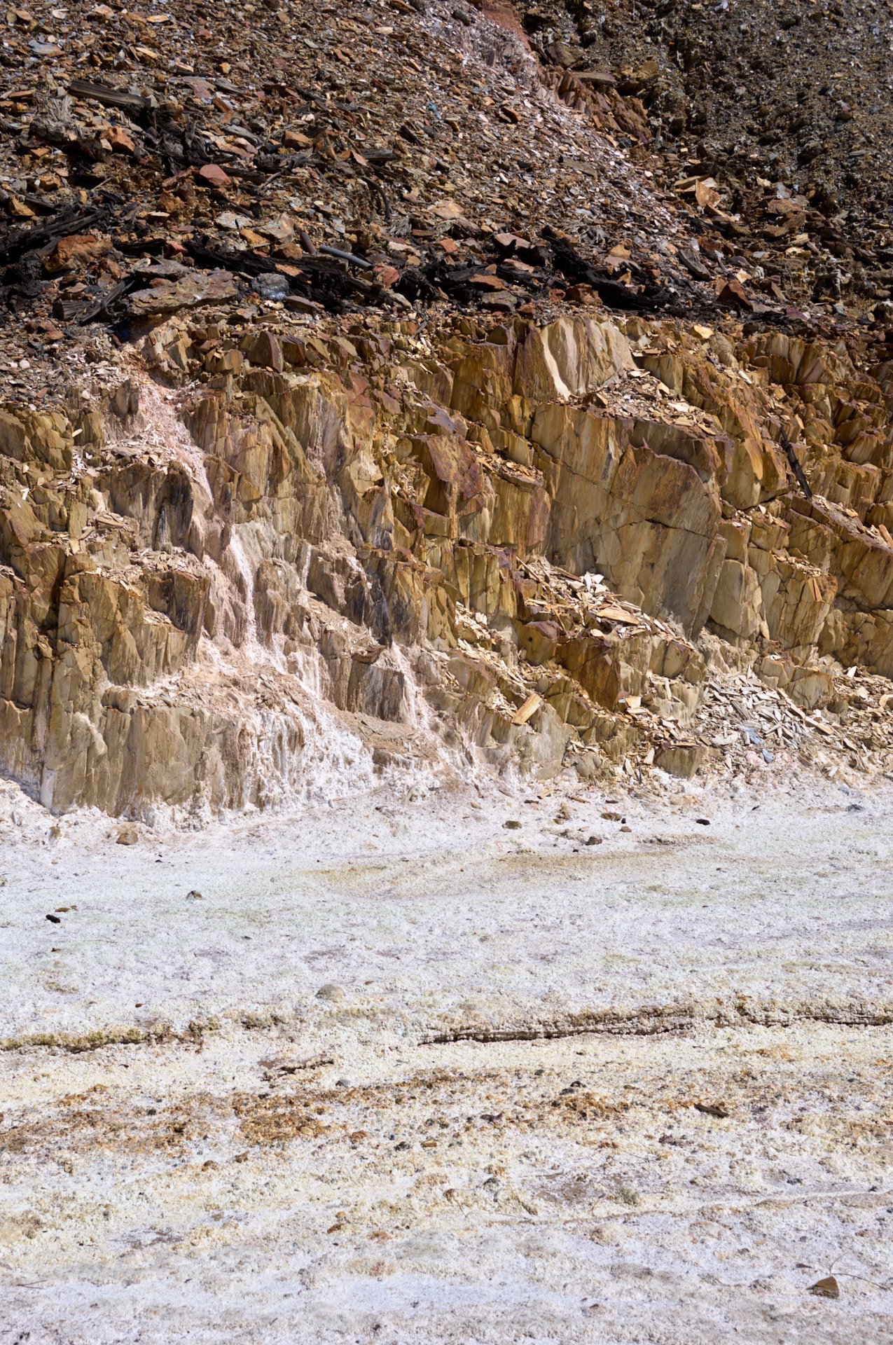 A rocky hillside with various sized rocks and dirt, showing signs of erosion and natural terrain.