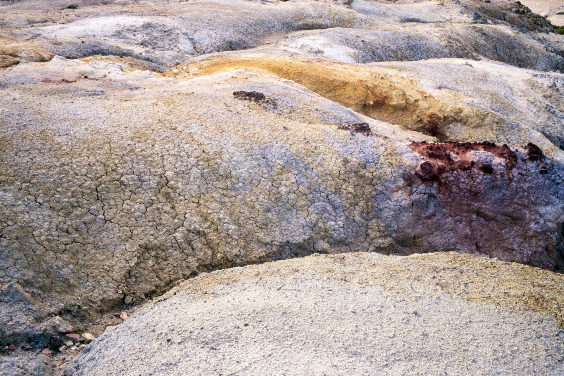 Close-up of cracked and weathered rocks in a desert landscape.