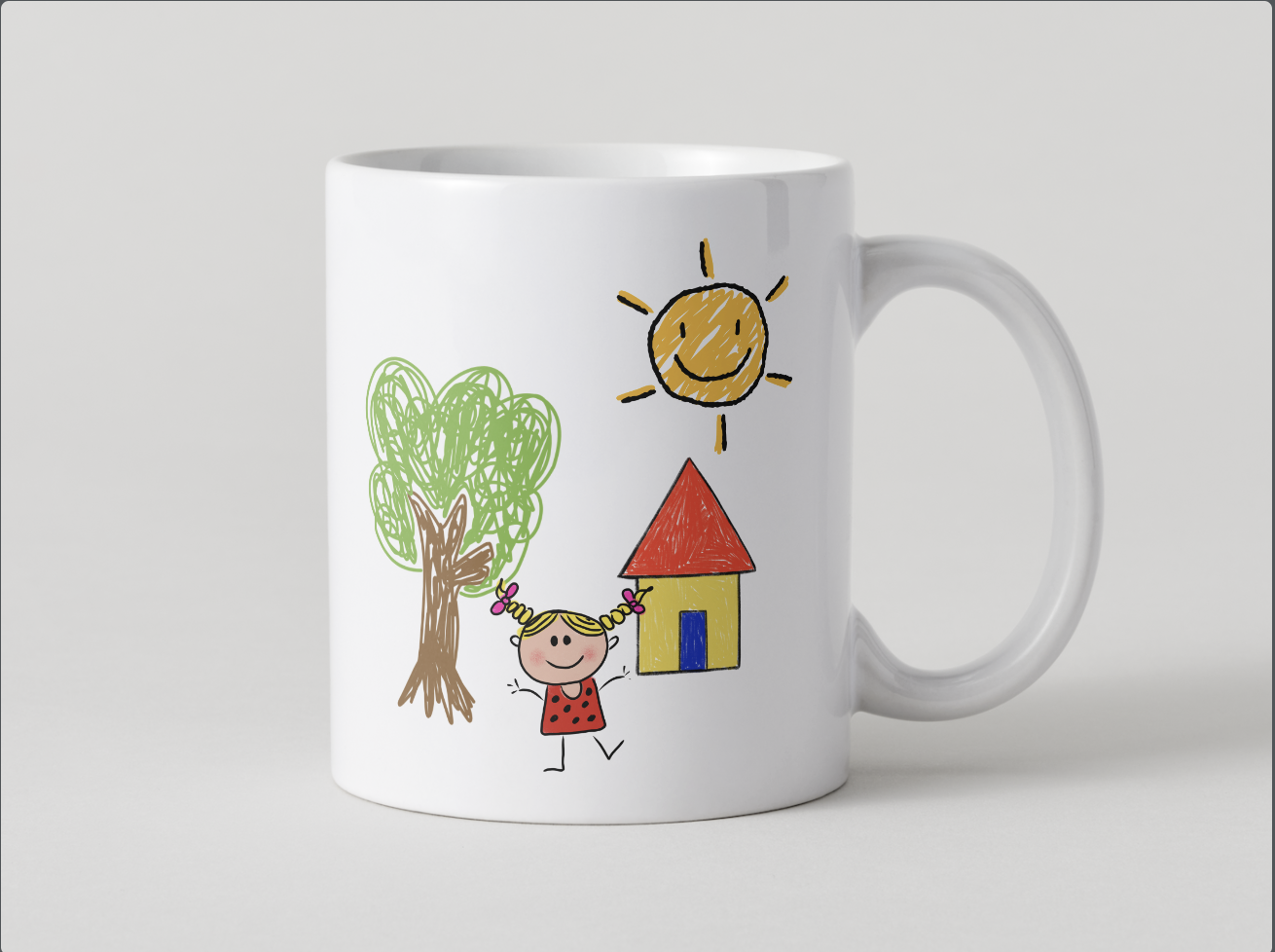 White mug with a colorful child's drawing of a smiling girl with pigtails, a tree, a house, and a smiling sun.