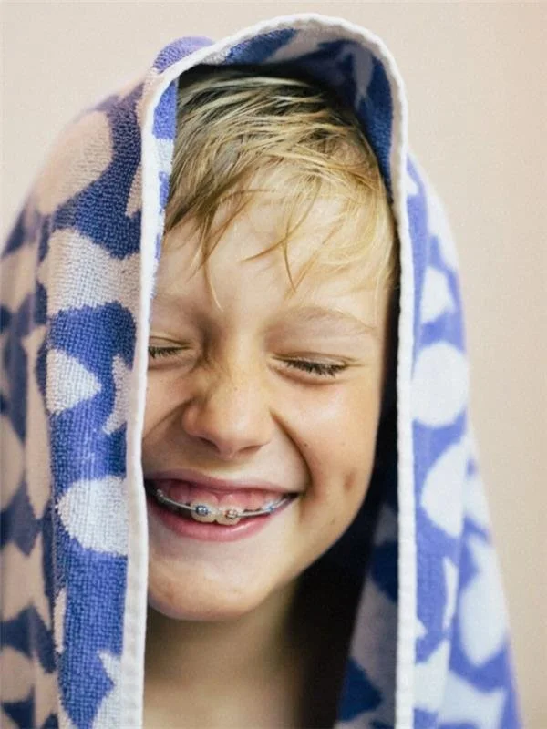 Child smiling with orthodontic braces during a pediatric orthodontic visit at Scarsdale Family Dental Group