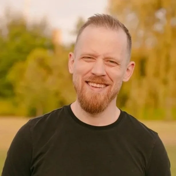Matt O’Leary smiling outdoors.