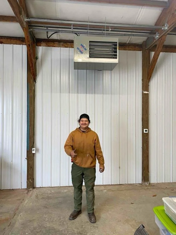 A garage heater installed into a pole barn.