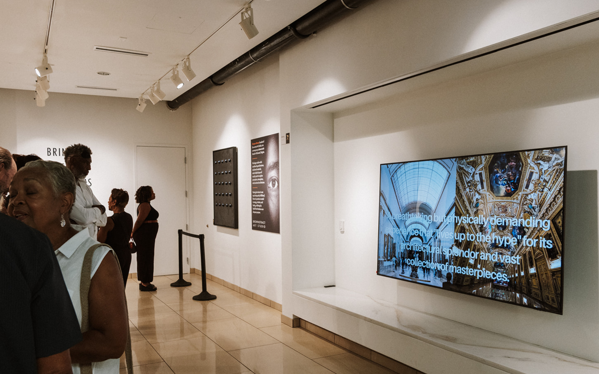 Guests viewing Brownstract artwork during a gallery exhibition.
