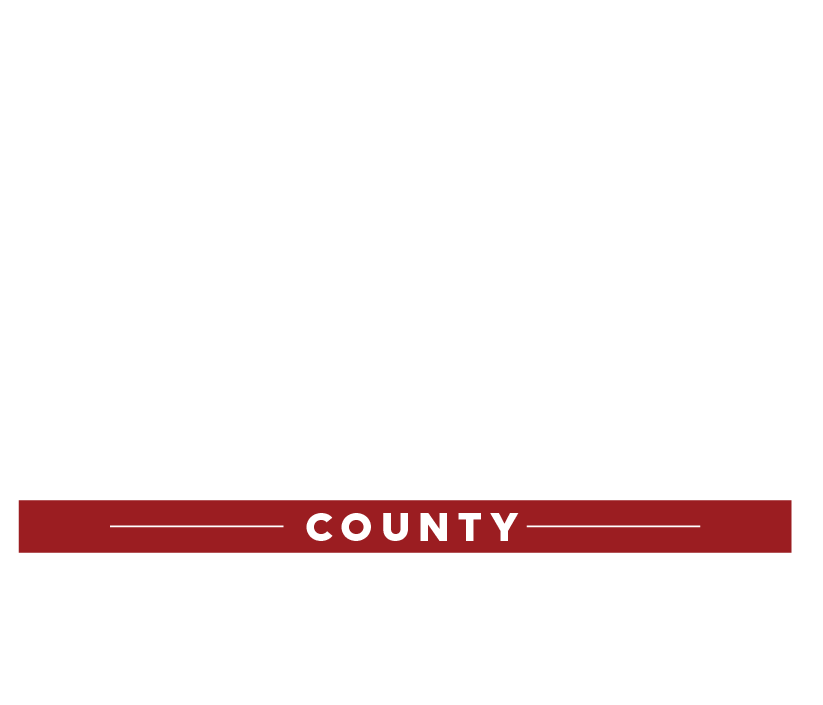 A political campaign sign supporting Bray County Judge Executive with white text on a black background, a red banner with white text reading 'County', and a white star at the top.