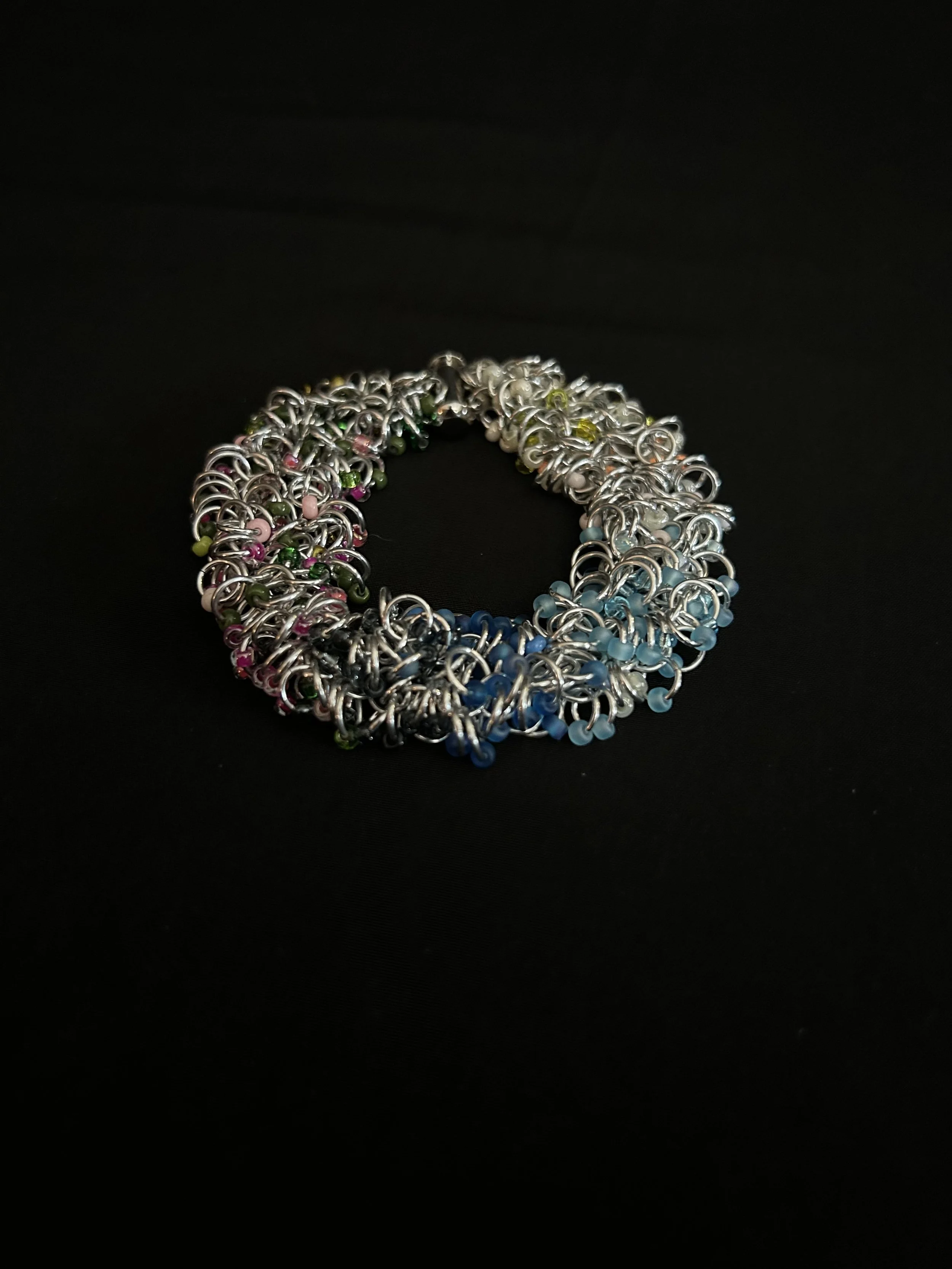 Blue Ridge Spring Bracelet laid flat to show the chainmaille weave and spring color palette.