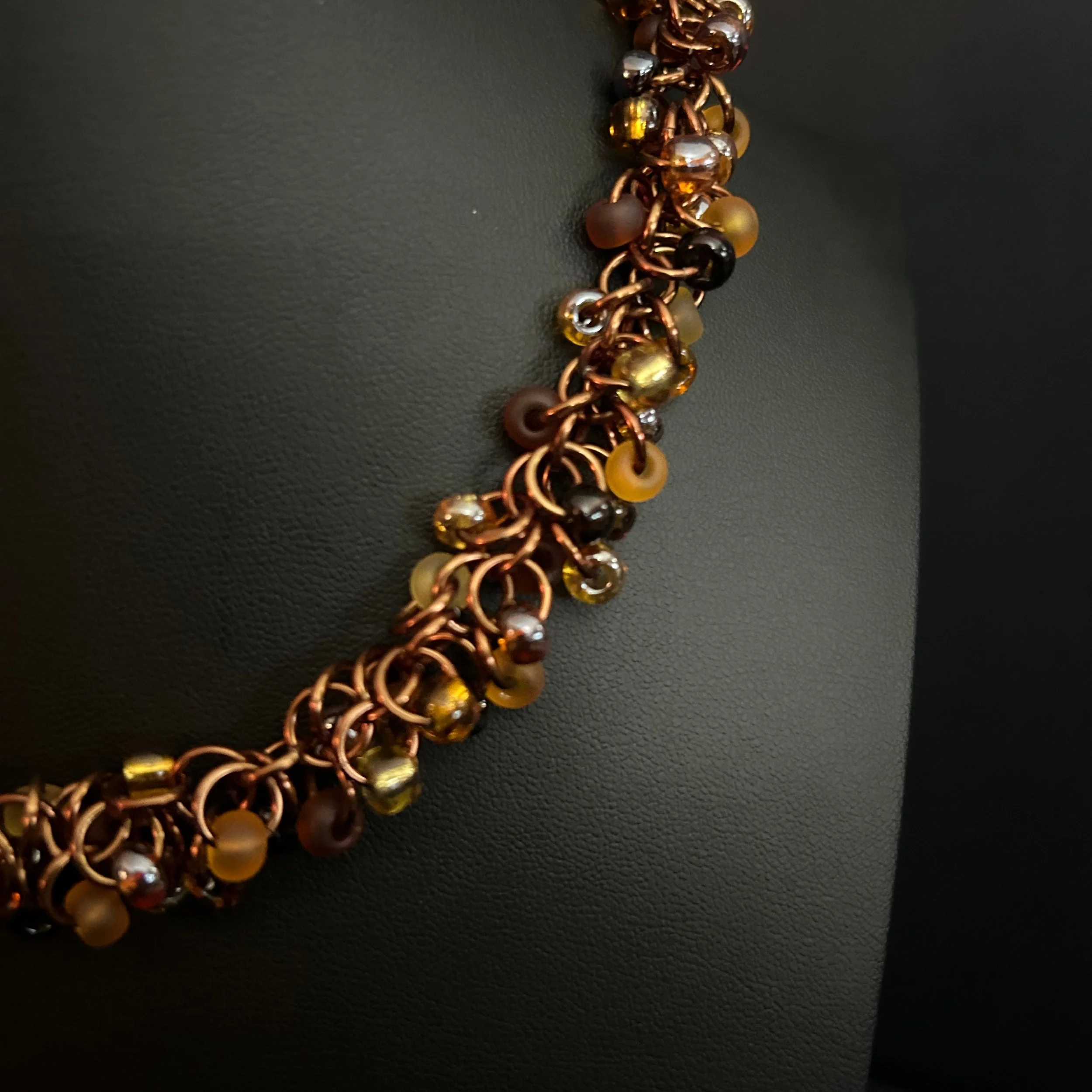 “Close-up of the shaggy‑loop rings and mixed‑finish Czech glass beads.”