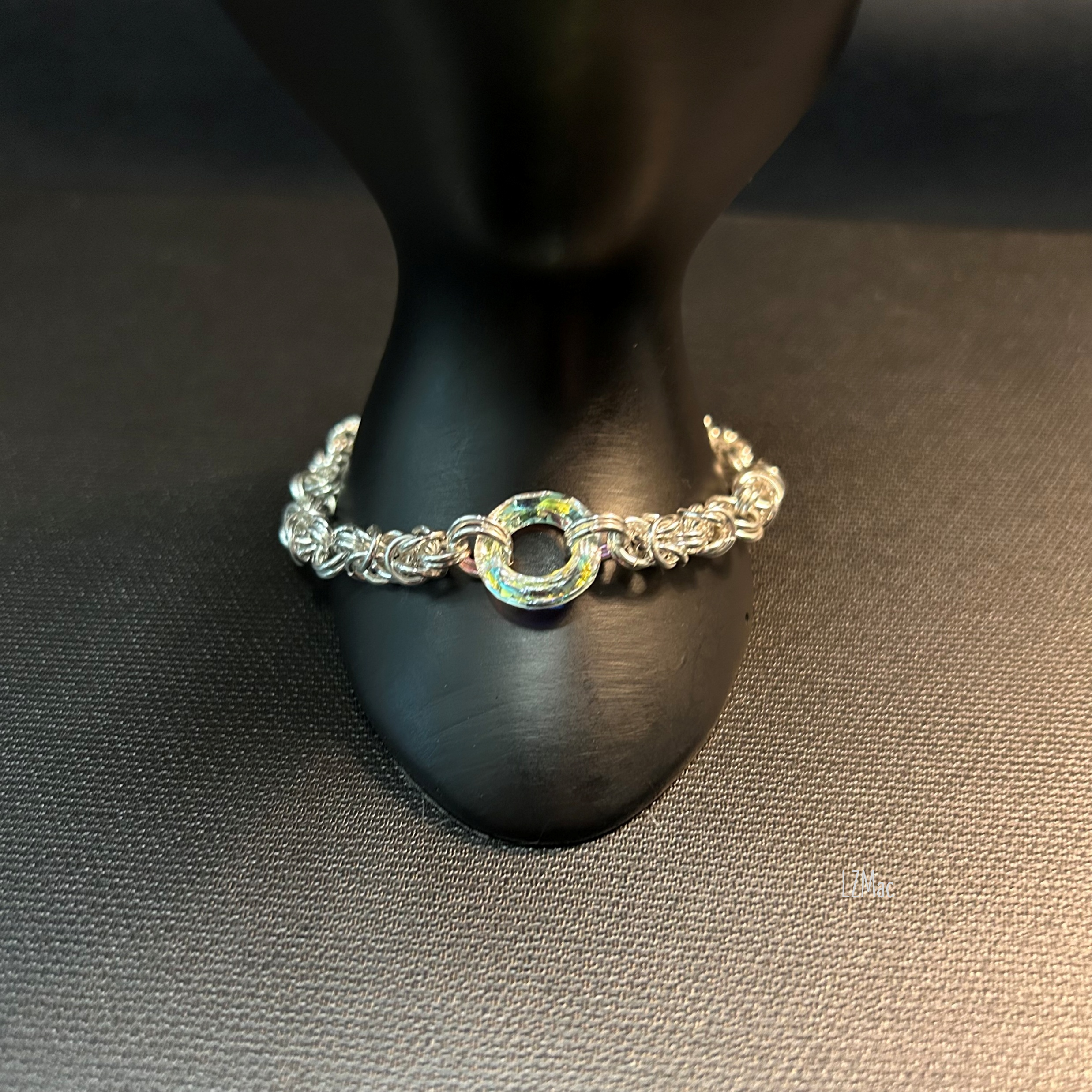ilver Halo Sterling Byzantine bracelet displayed on a dark prop highlighting the Swarovski halo crystal.