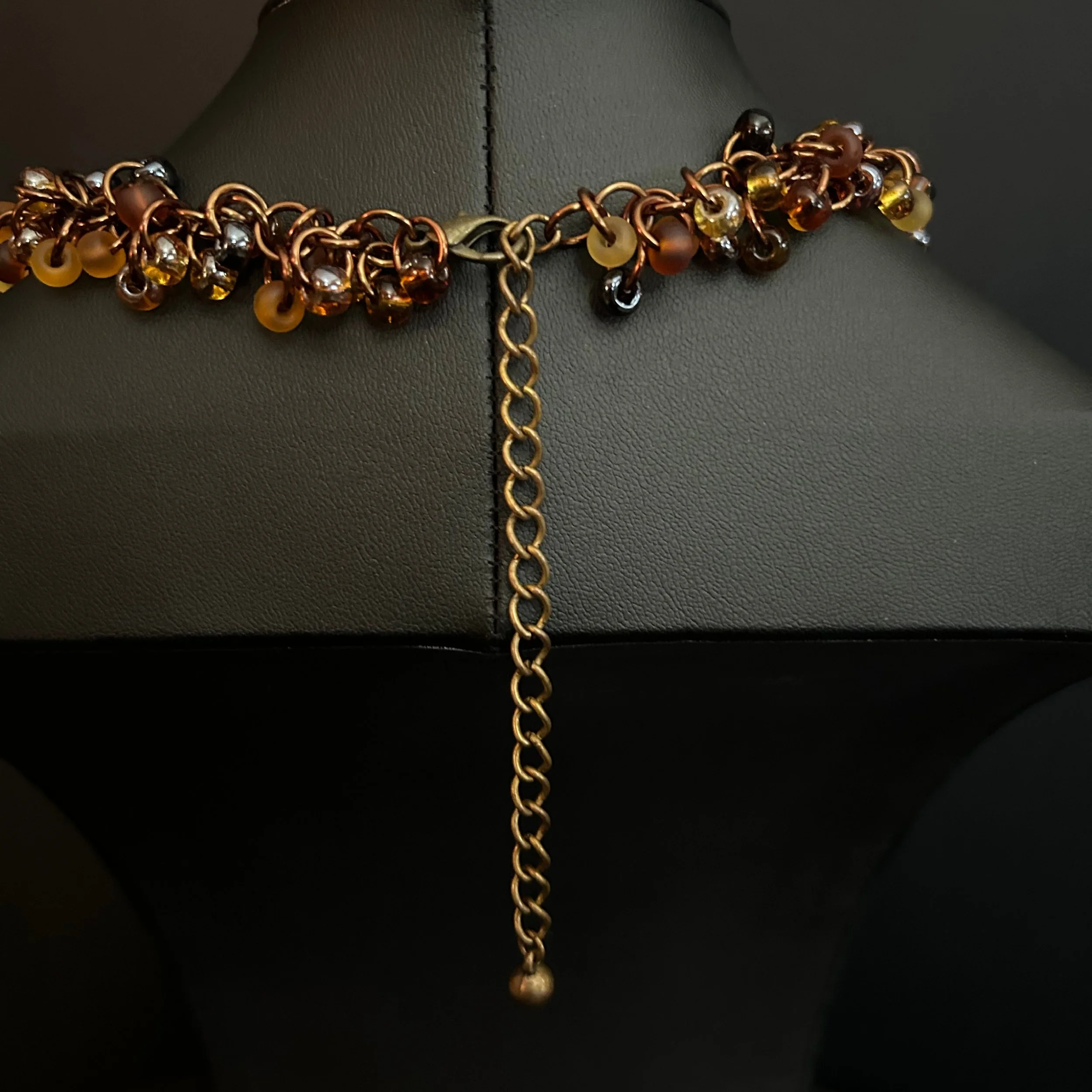 “Close-up of the bronze‑tone clasp and connecting rings.”
