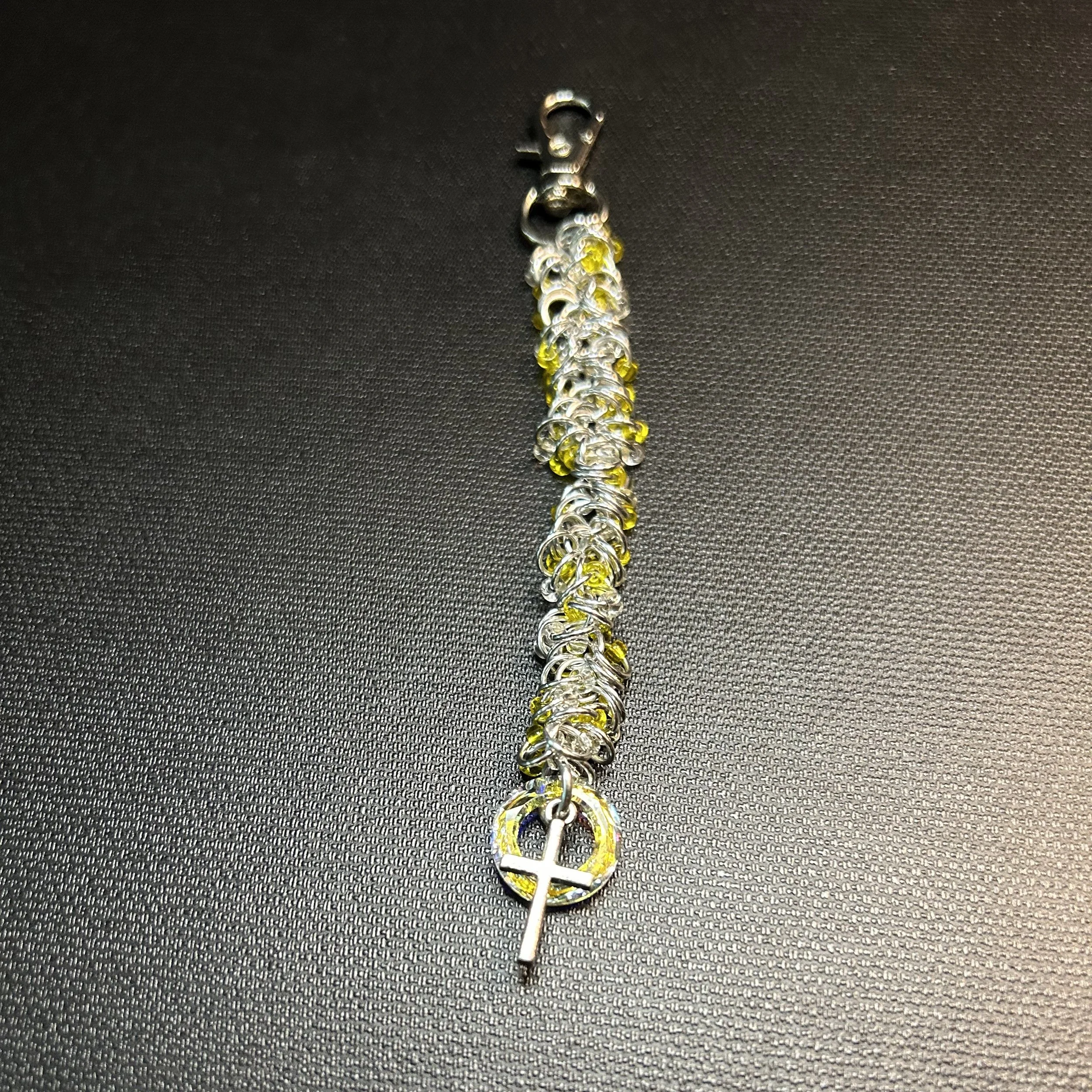 Silver and yellow accent purse charm with Swarovski crystal donut and silver cross charm, 5.25 inches long with swivel clasp