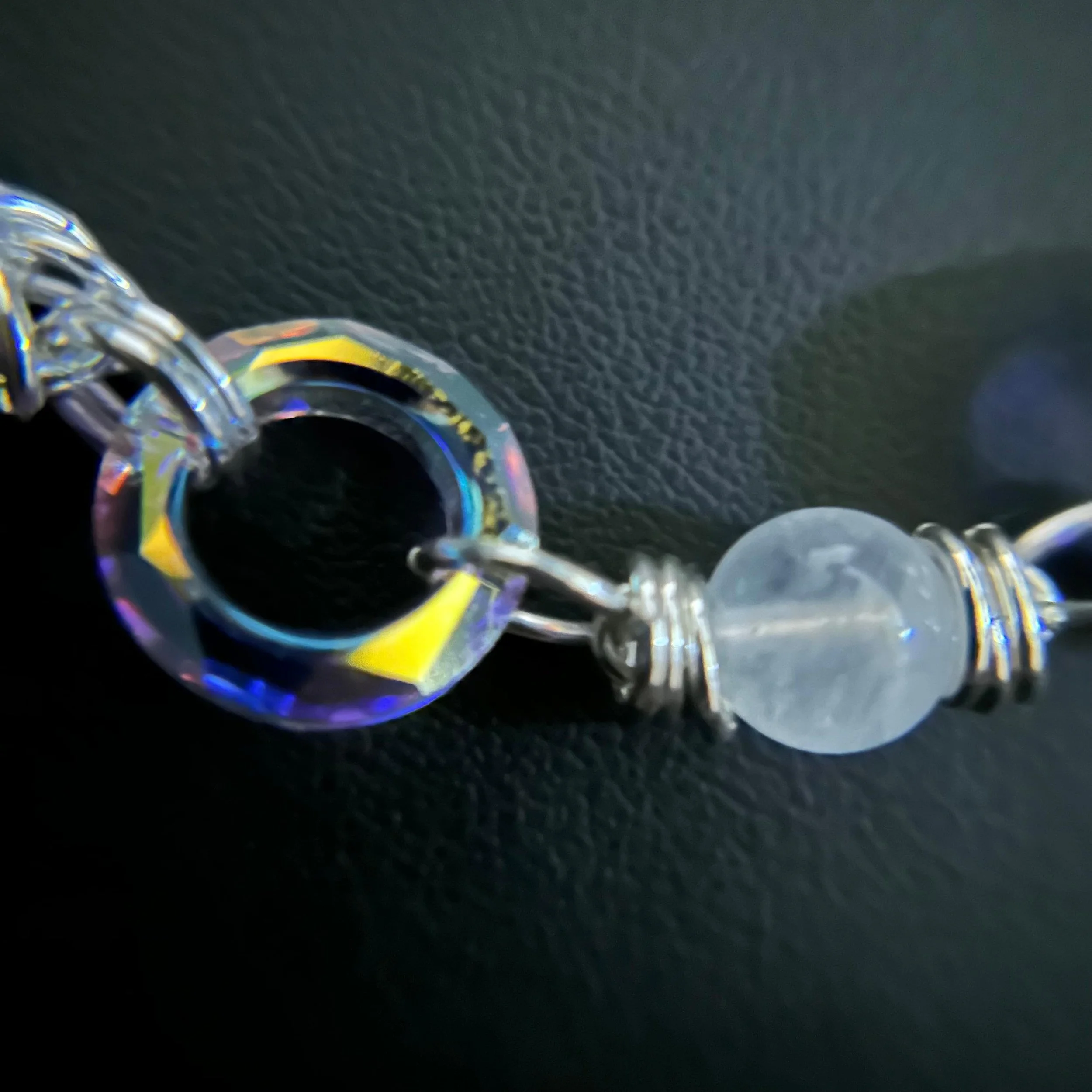 Close-up of the Silver Starlight necklace showing an 8mm moonstone bead and Swarovski crystal with sterling wirework.