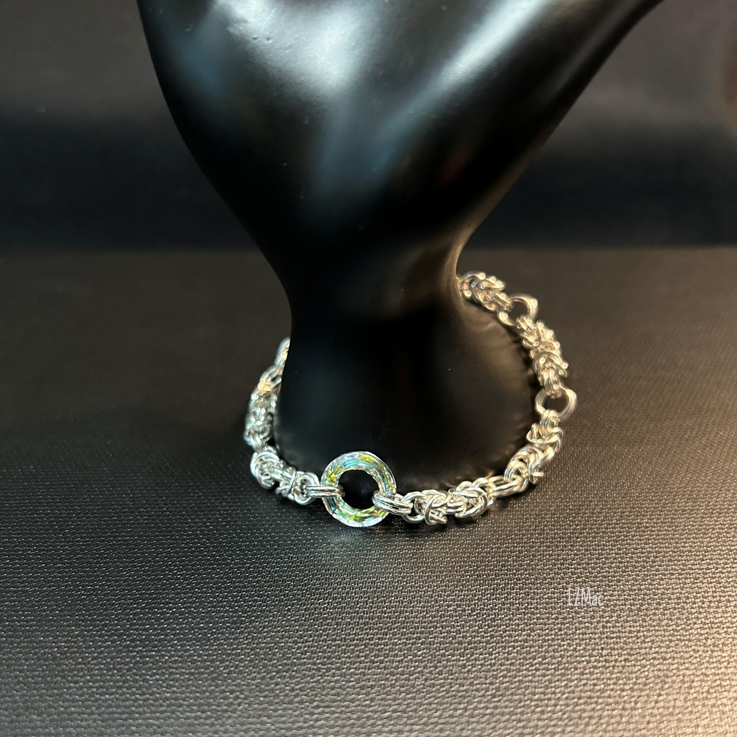Silver Halo Sterling Byzantine bracelet displayed on a dark prop highlighting the Swarovski halo crystal.