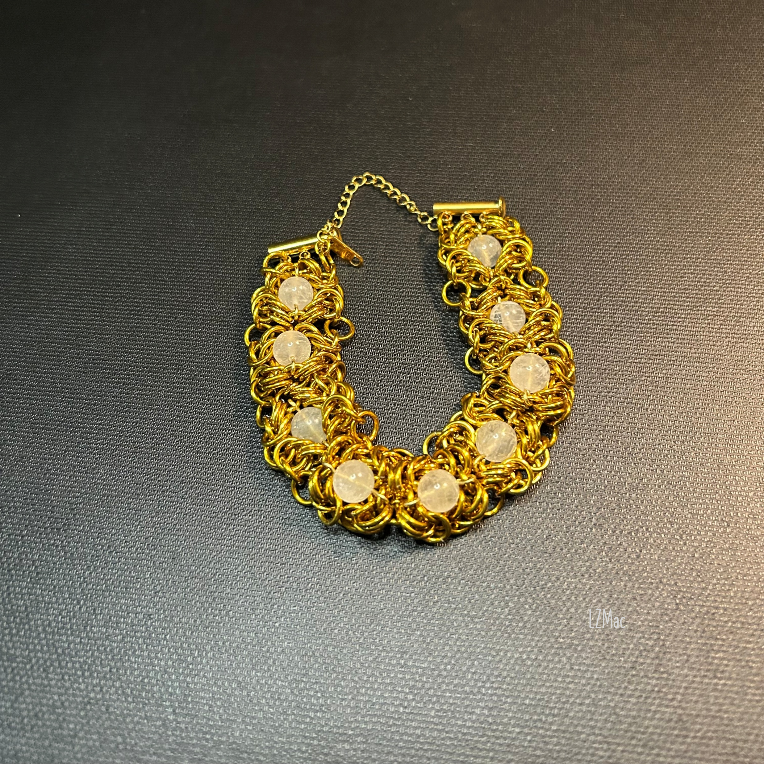 Flat open view of the Moonlit Rosette Bracelet with stainless slide‑lock clasp and safety chain.