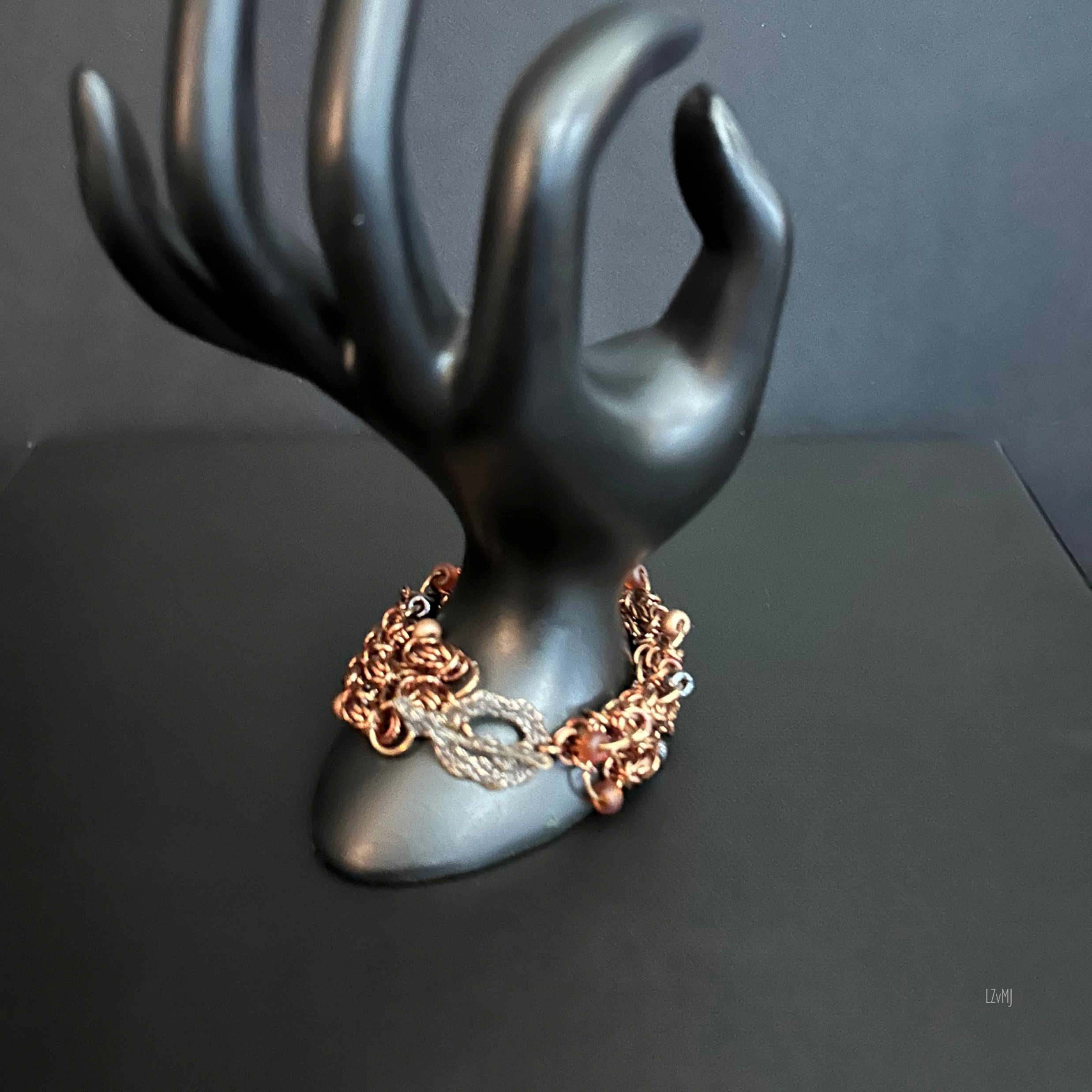 “Bracelet on display prop with the bronze toggle clasp clearly visible.”